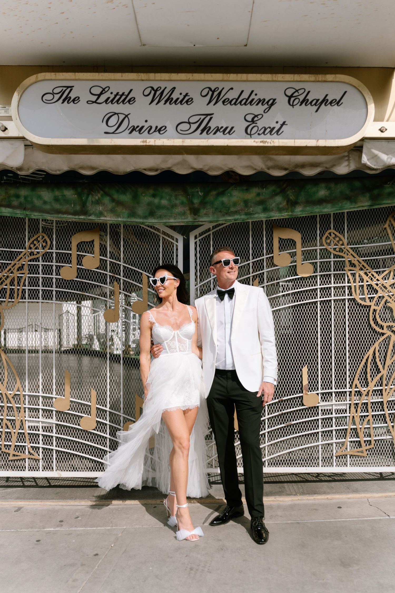 Wedding couple poses outside The Little White Wedding Chapel in Las Vegas.