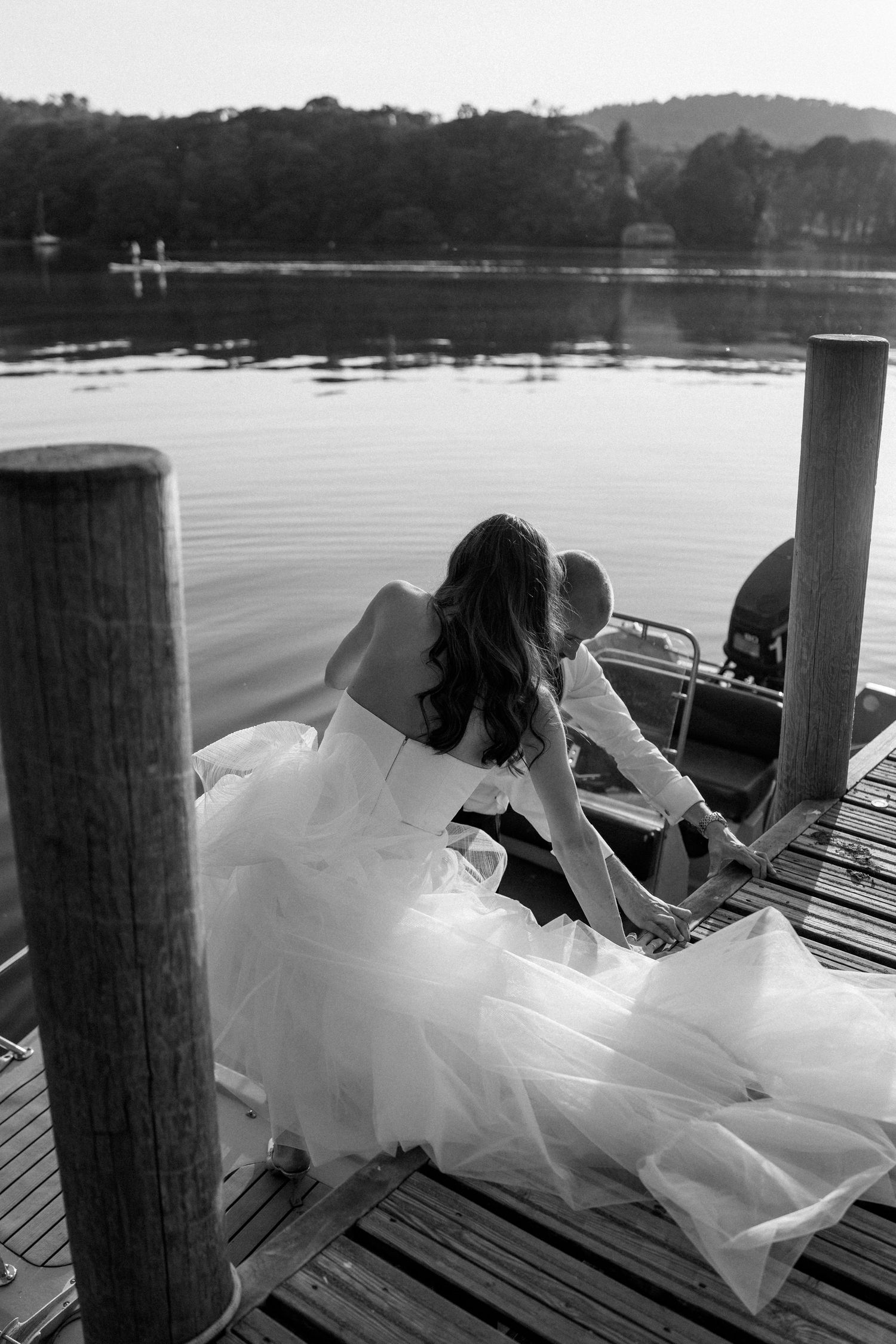 Wedding photo sequence showing couple lying on lakeside dock at dusk.