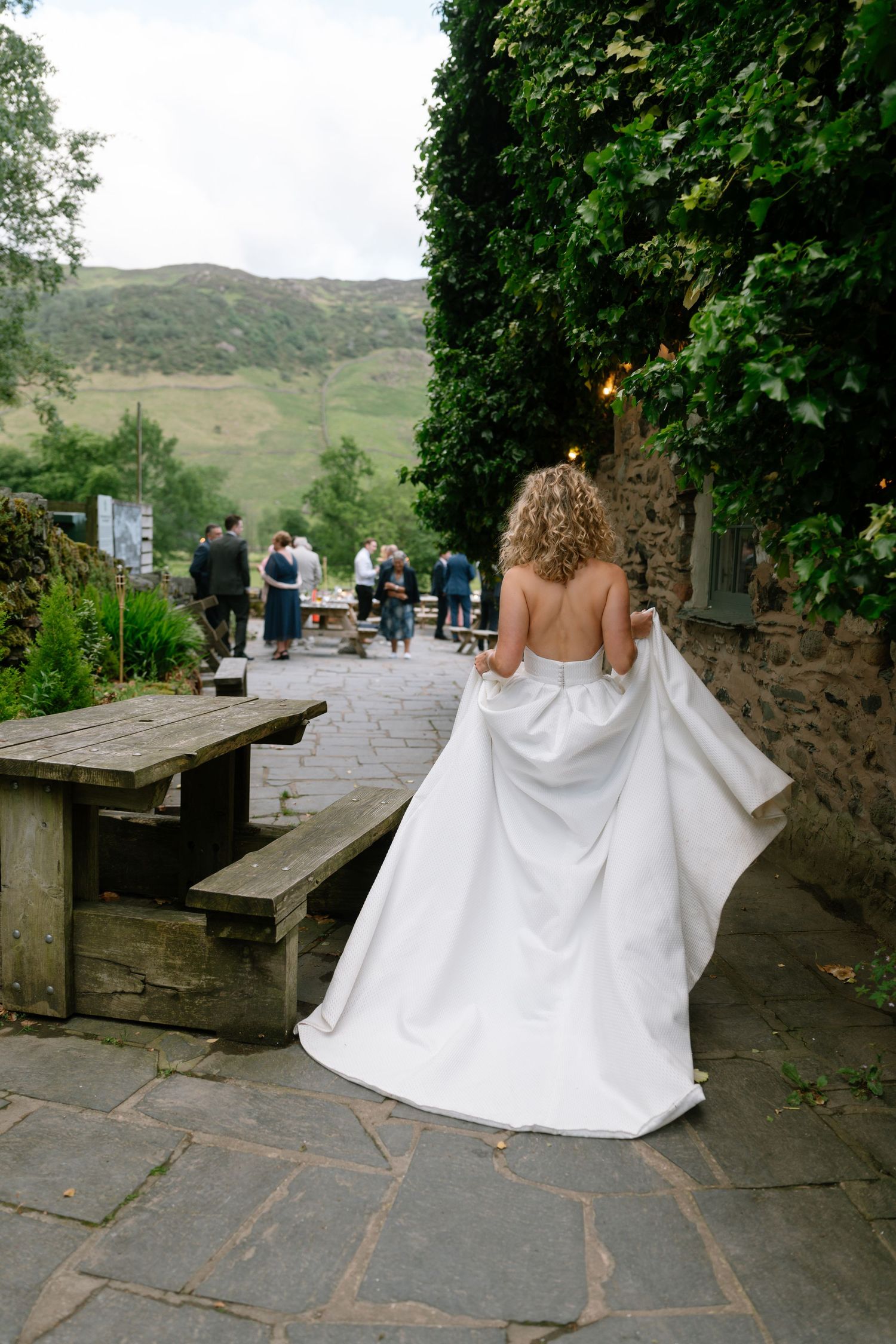 Wedding celebration on a stone patio with scenic mountain views in the background.