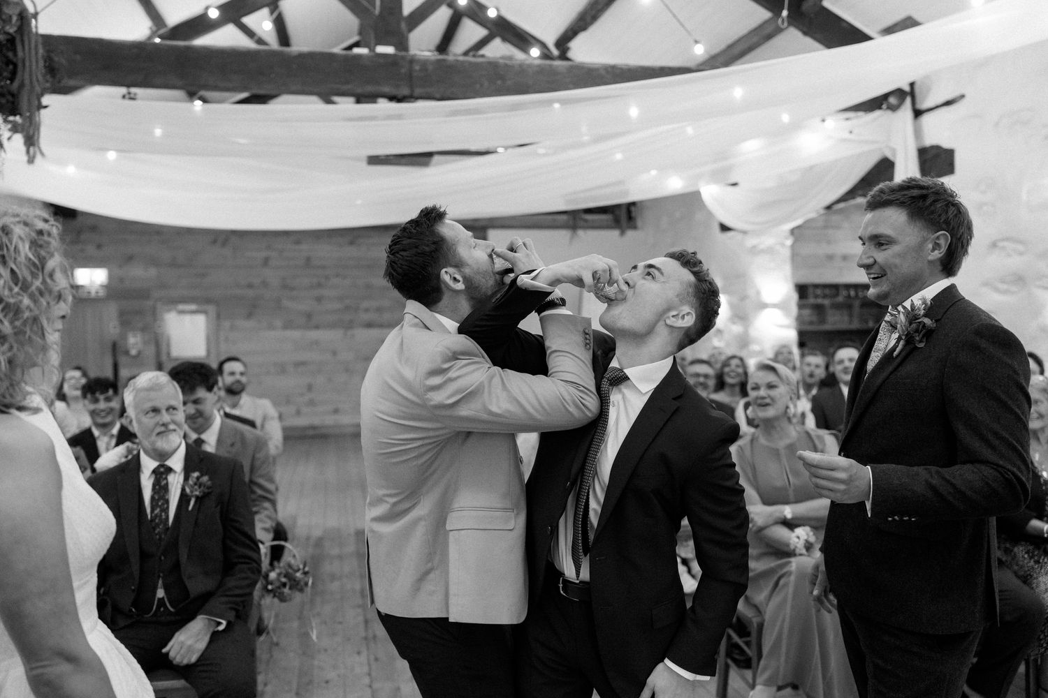 Black and white candid shots of wedding reception celebrations.