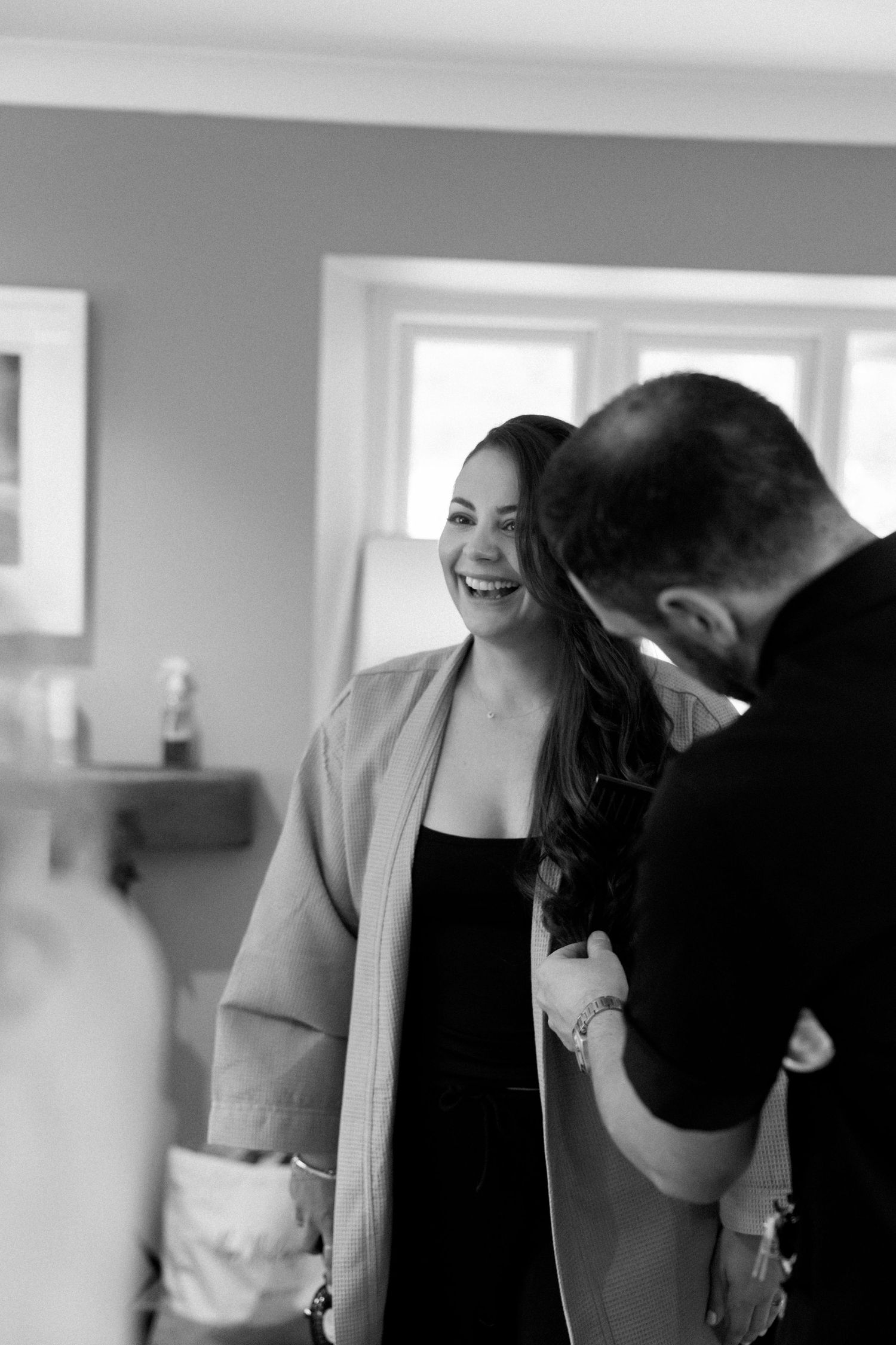 Black and white photo sequence showing wedding preparation moments in an indoor setting.