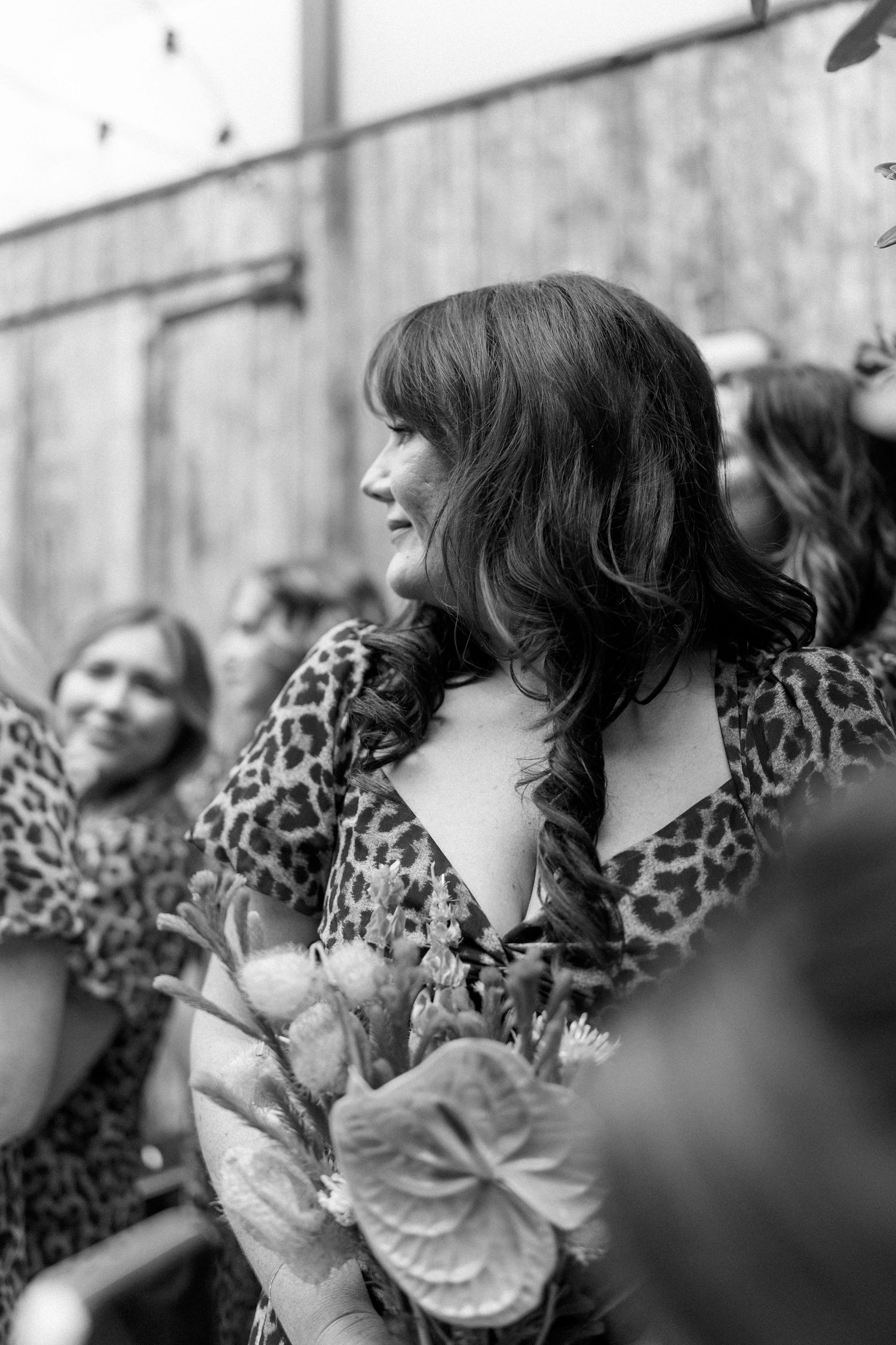 Close-up black and white shots of guests in leopard print attire at a wedding.