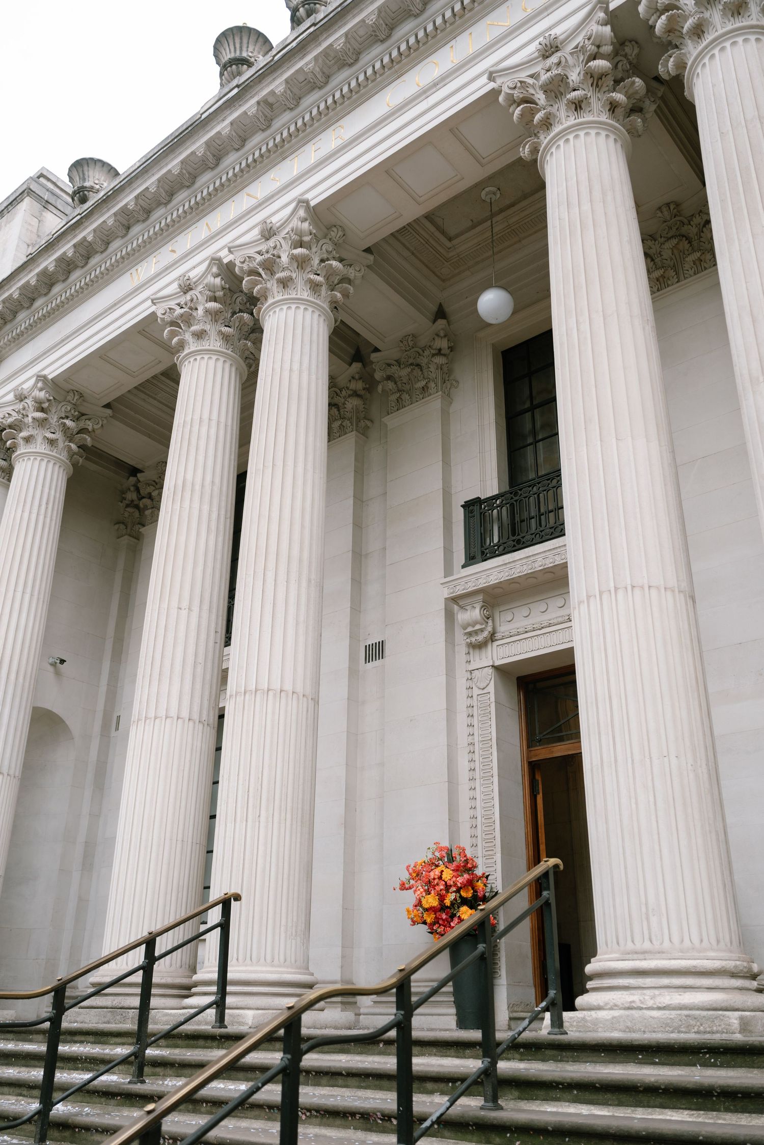 A grand neoclassical building facade with towering white columns and ornate architectural details.