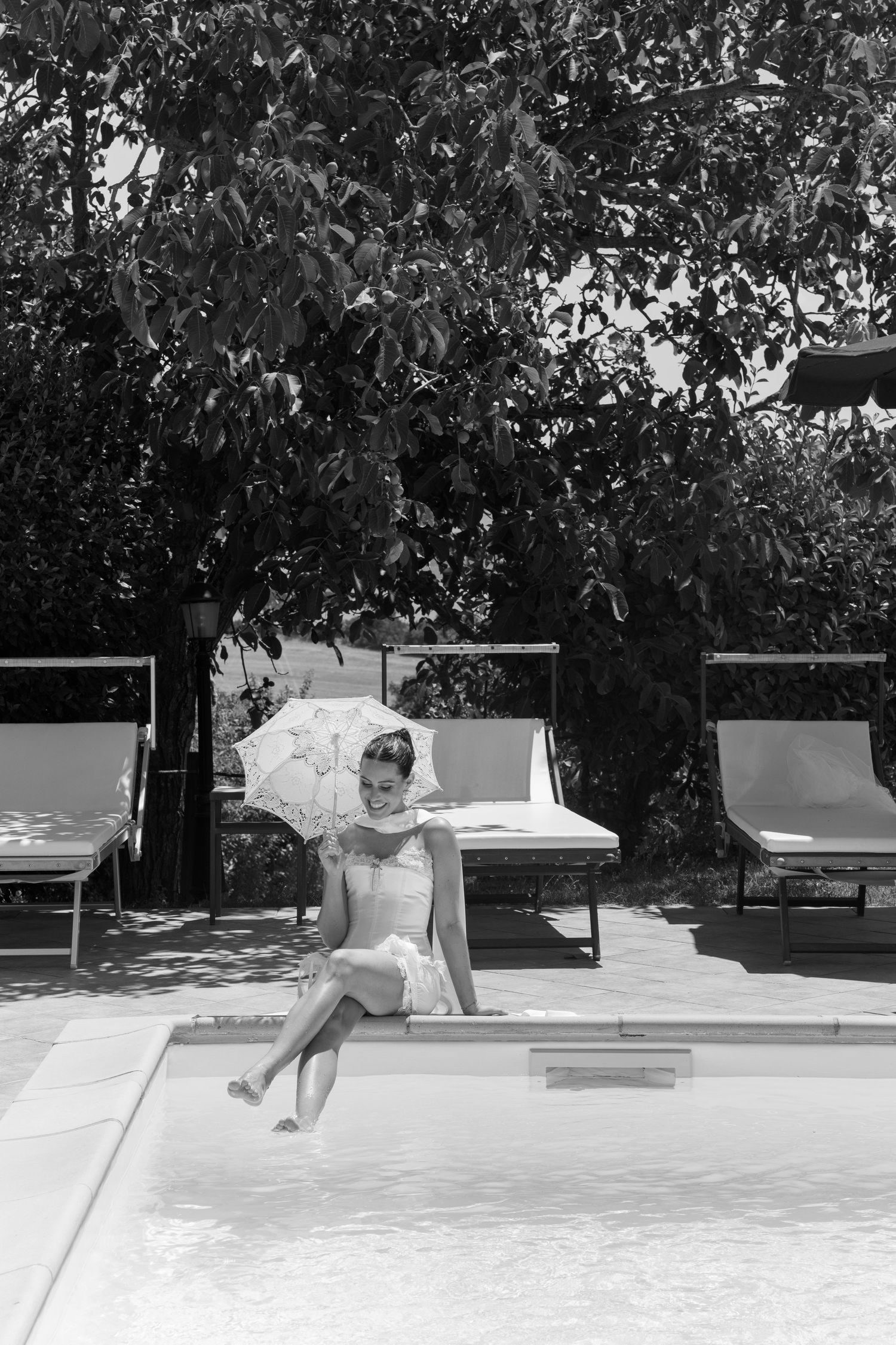 Sequential black and white photos showing a person lounging by a pool in an outdoor setting.
