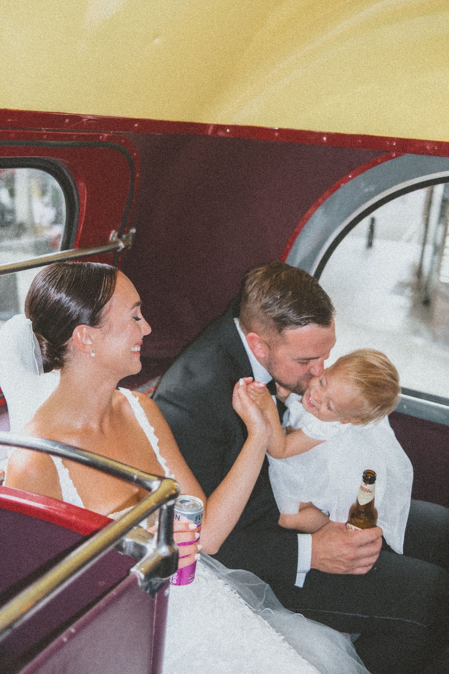 A series of photos showing a couple sharing intimate kisses inside a vintage red car.