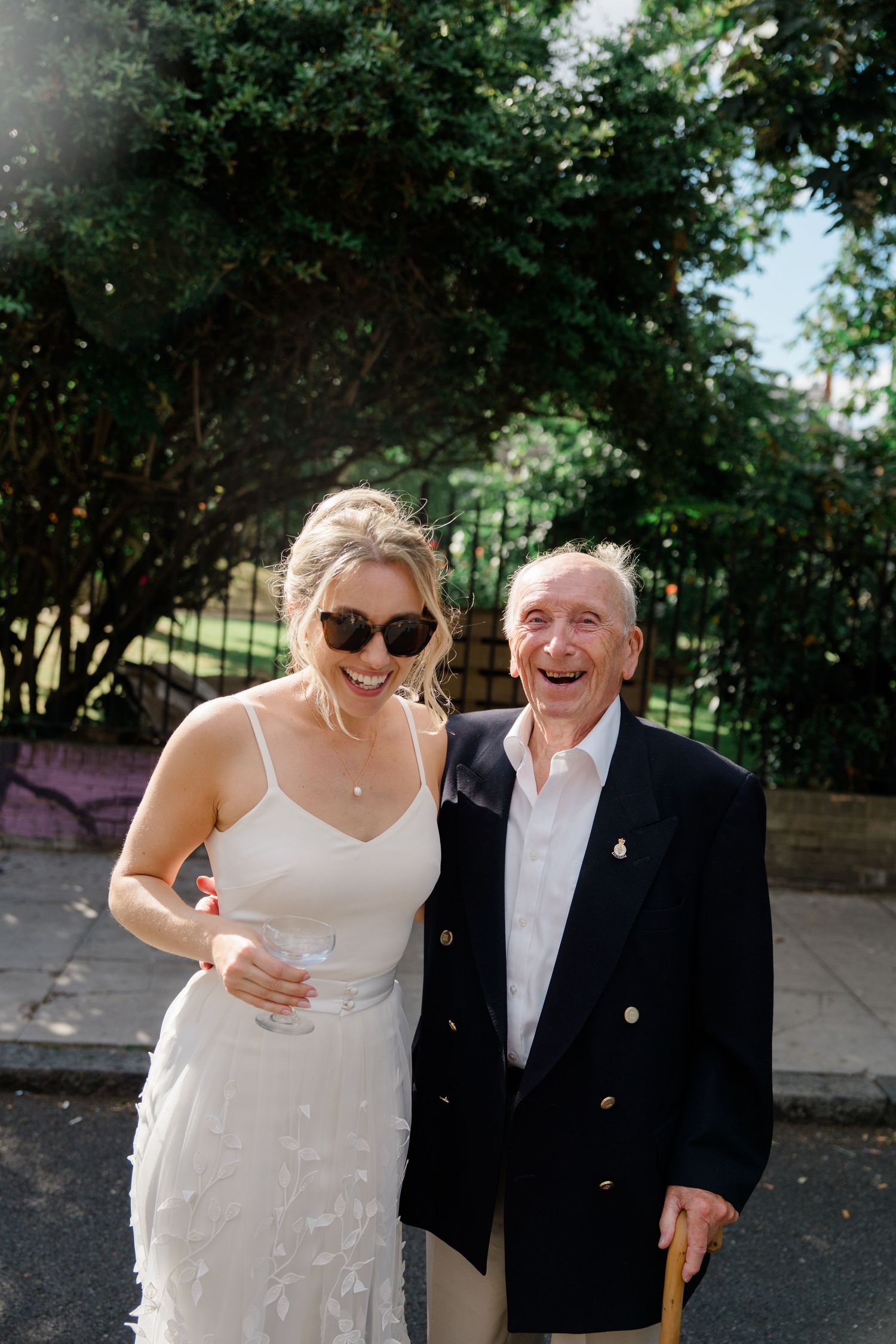 A joyful outdoor moment captured in sunlit garden setting.