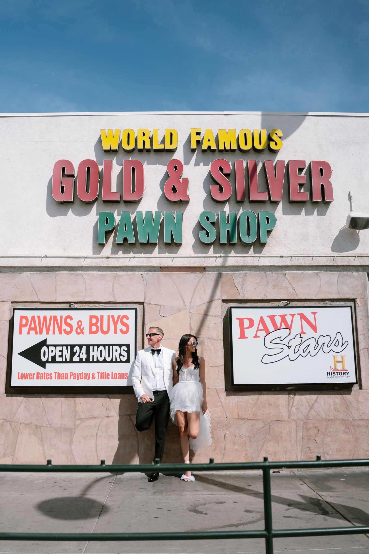 Exterior view of a World Famous pawn shop with multiple business signs.