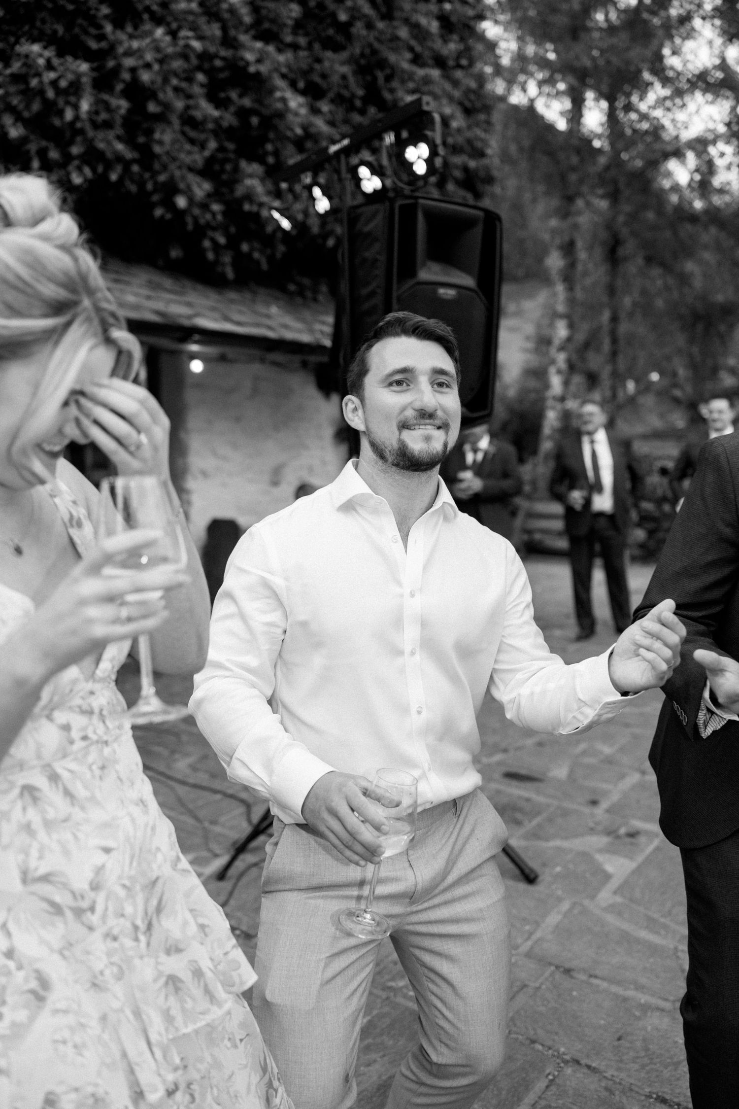 Wedding celebration showing guests dancing and having fun at an outdoor reception.