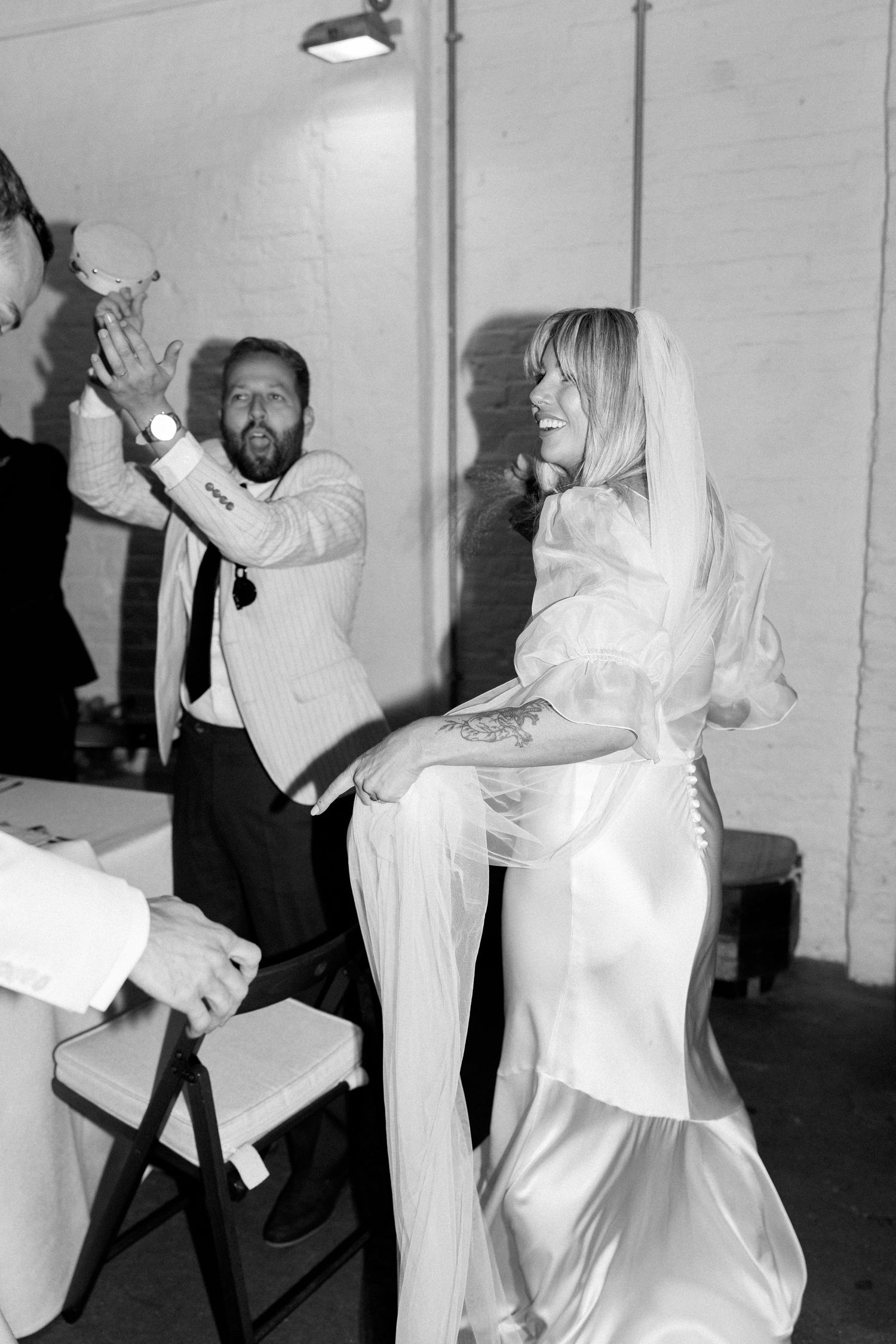 Black and white photos show dancers in white outfits performing energetic dance moves.