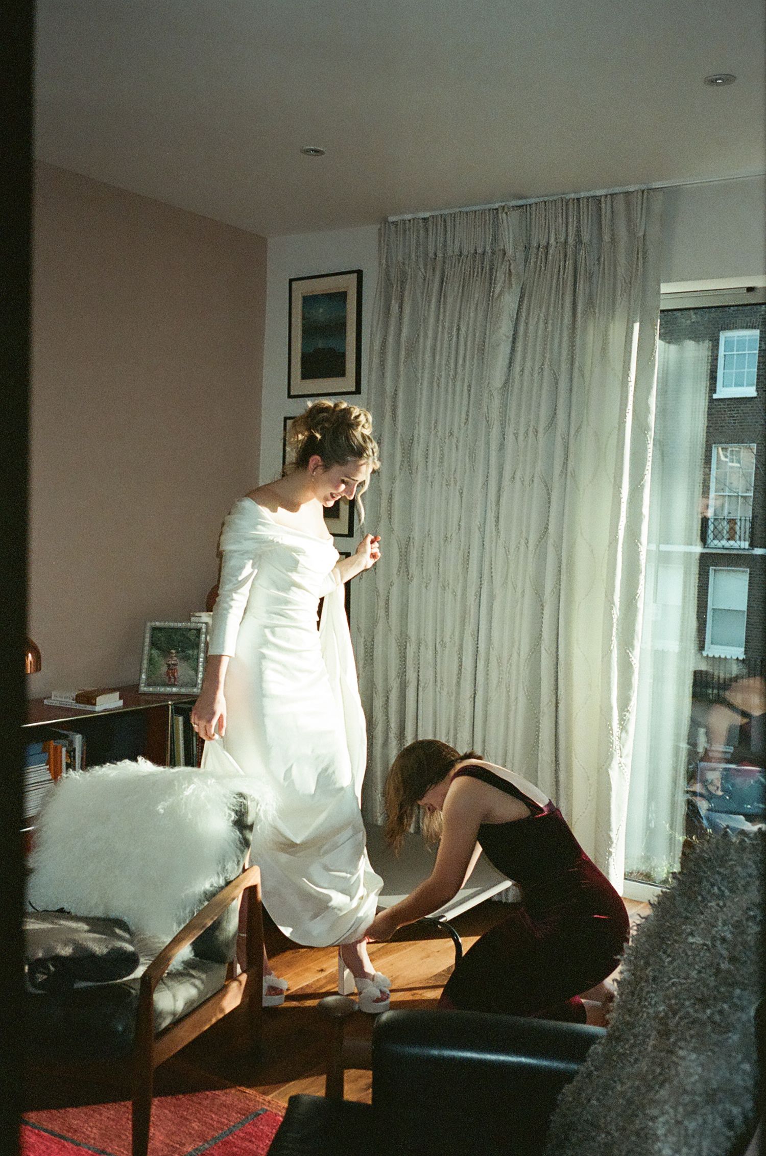 A sequence of playful moments in a bright room with white curtains and natural lighting.