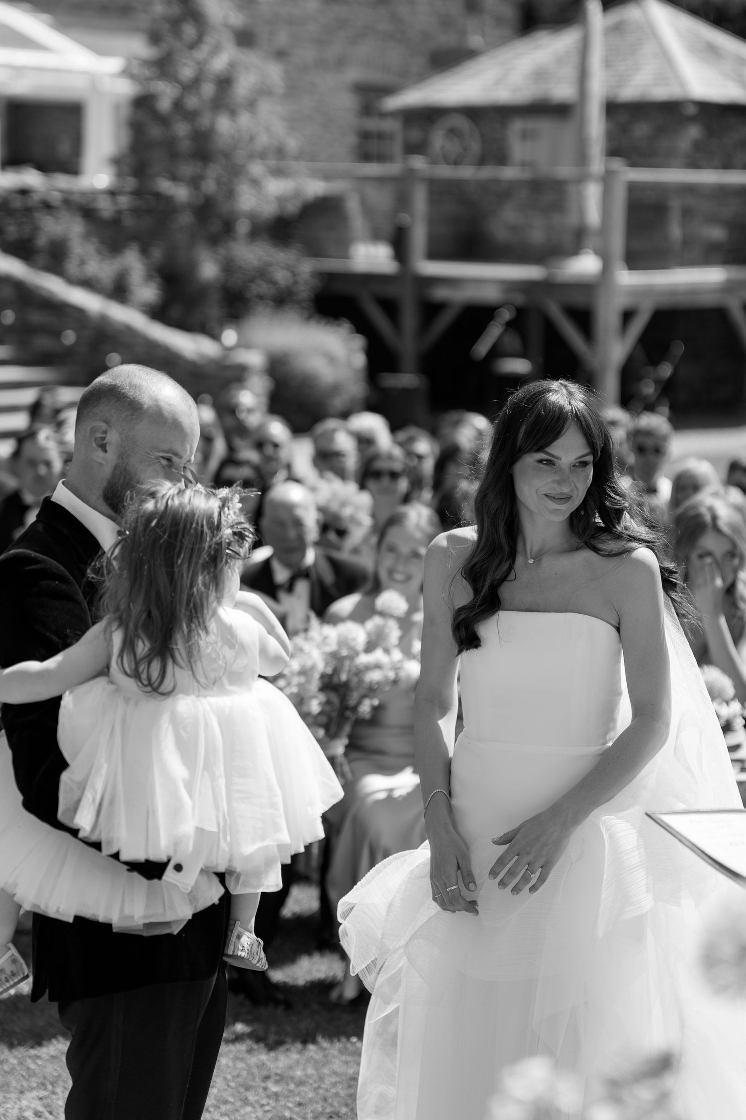 Wedding couples share intimate dances during outdoor reception in black and white.