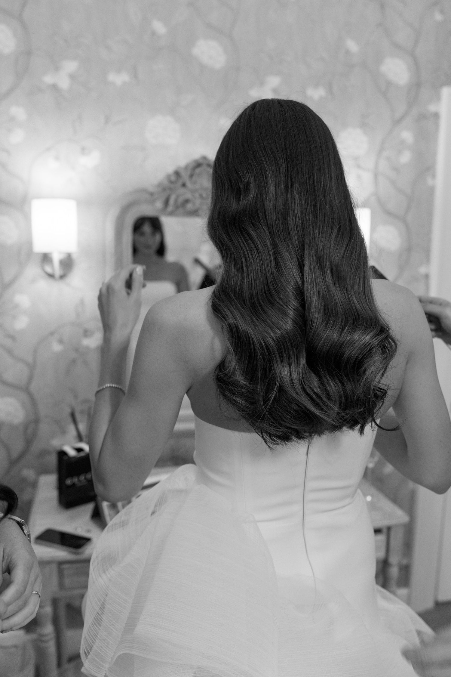 Black and white sequence showing the back of a person in a white dress making playful movements.