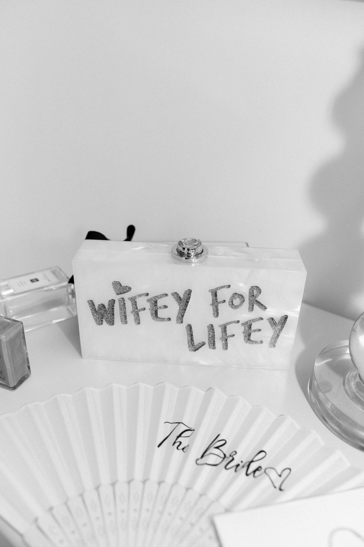 White paper fans with handwritten text arranged on light surface.
