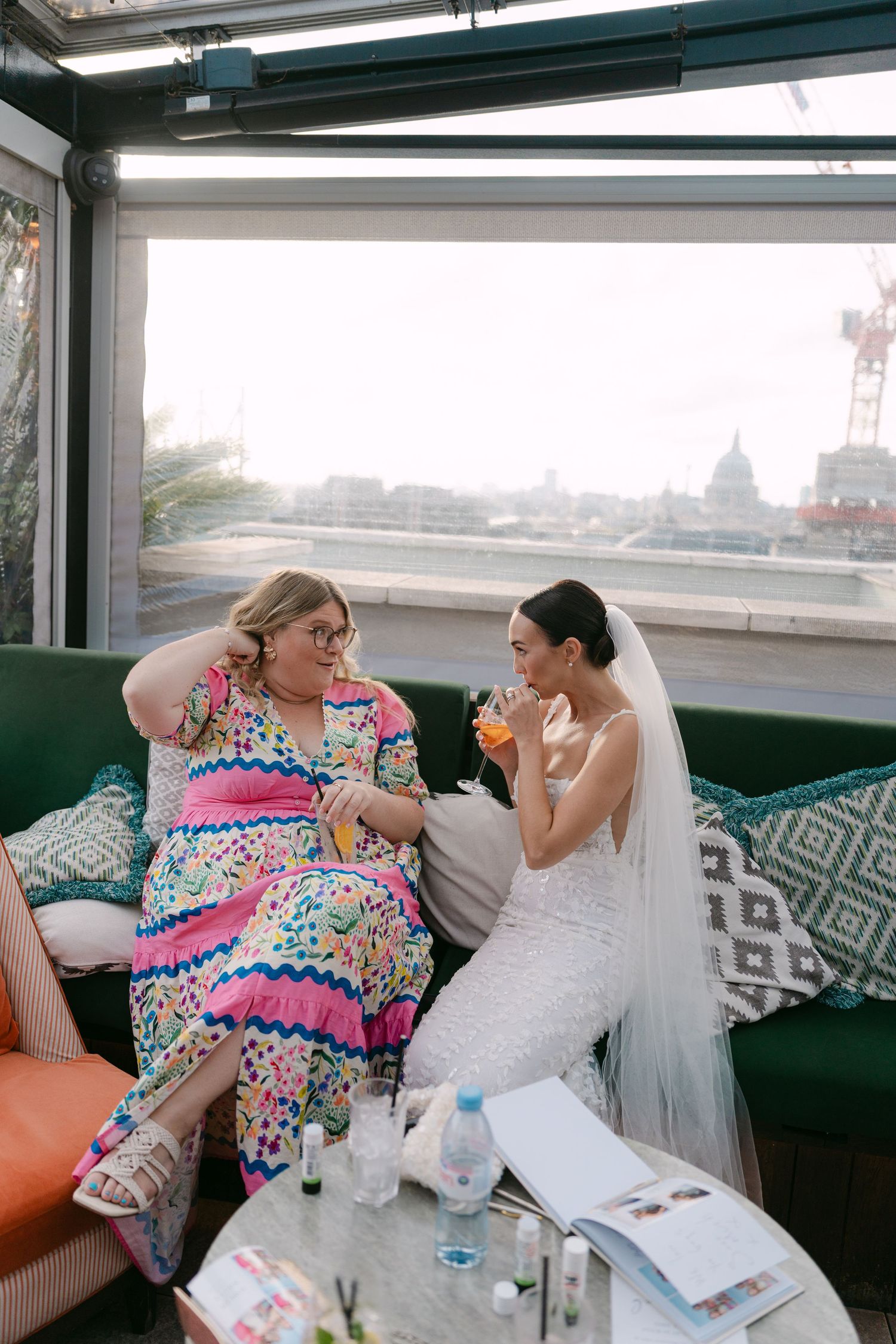 Wedding guests relaxing on modern furniture at indoor reception venue.