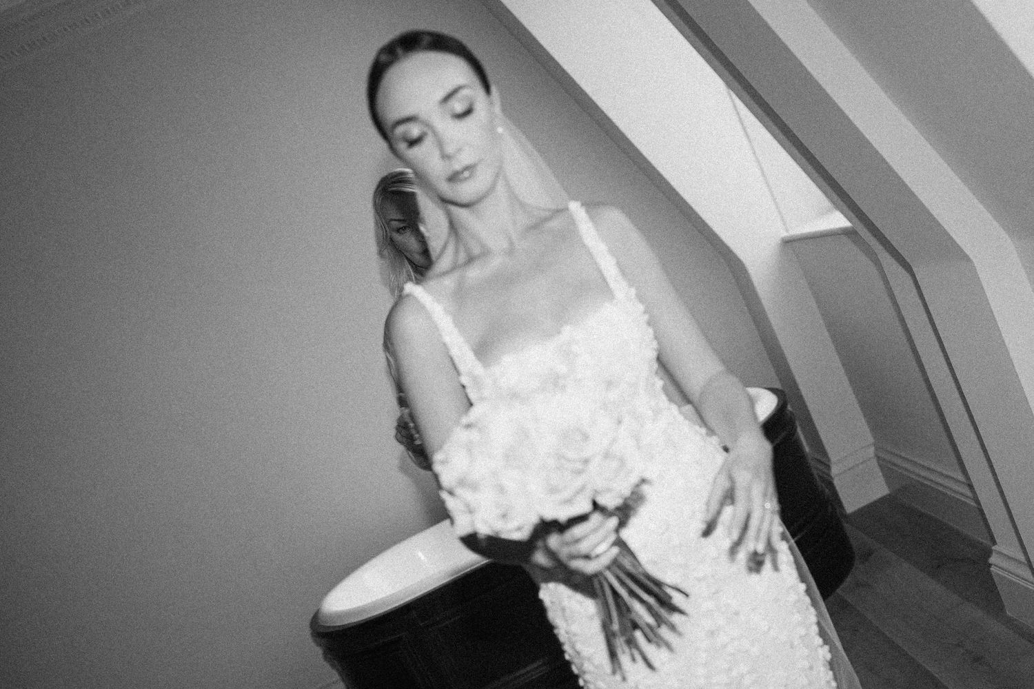Black and white candid moments of bridal preparation in elegant setting.