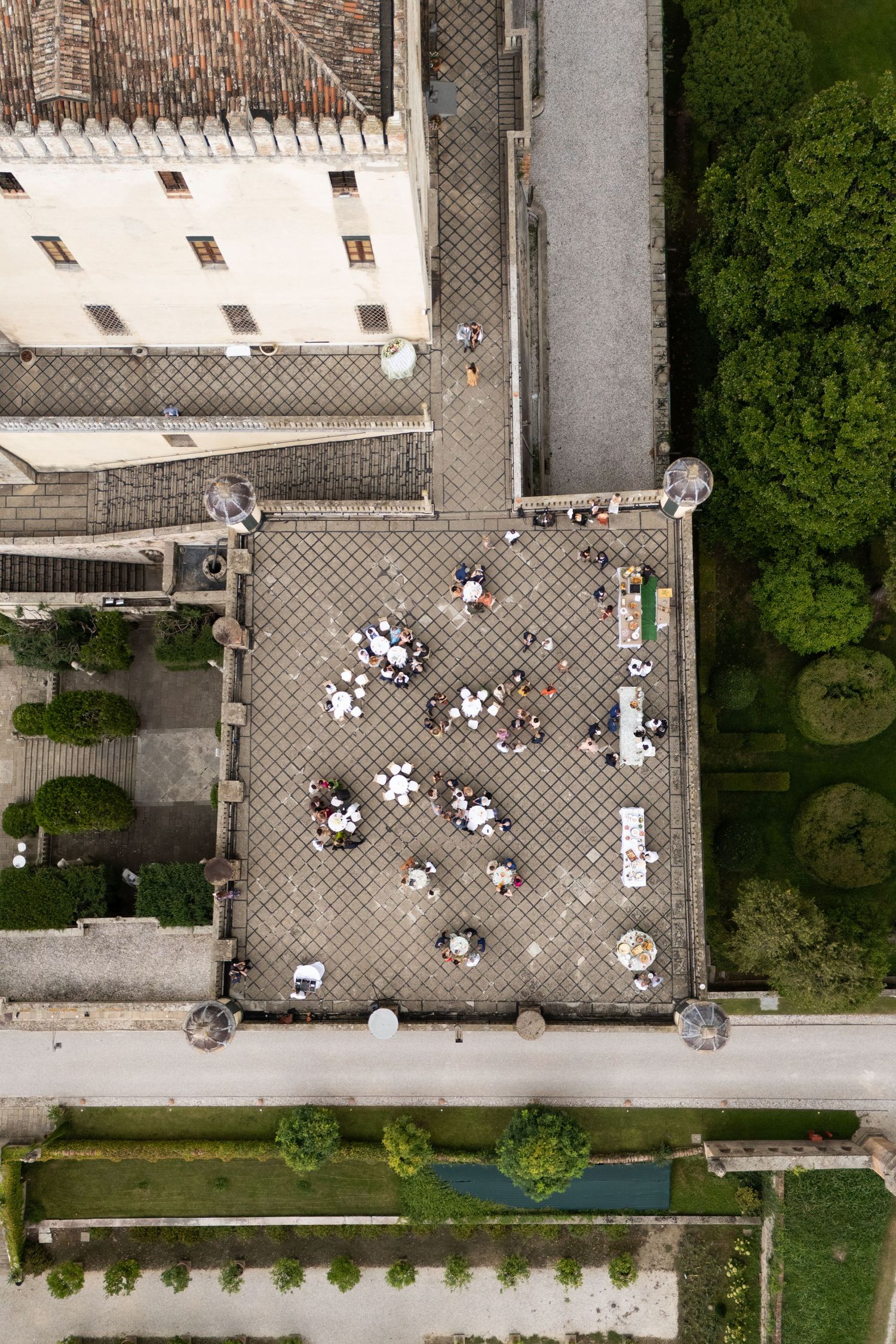 Aerial view of a courtyard with scattered tables and chairs seen from above.