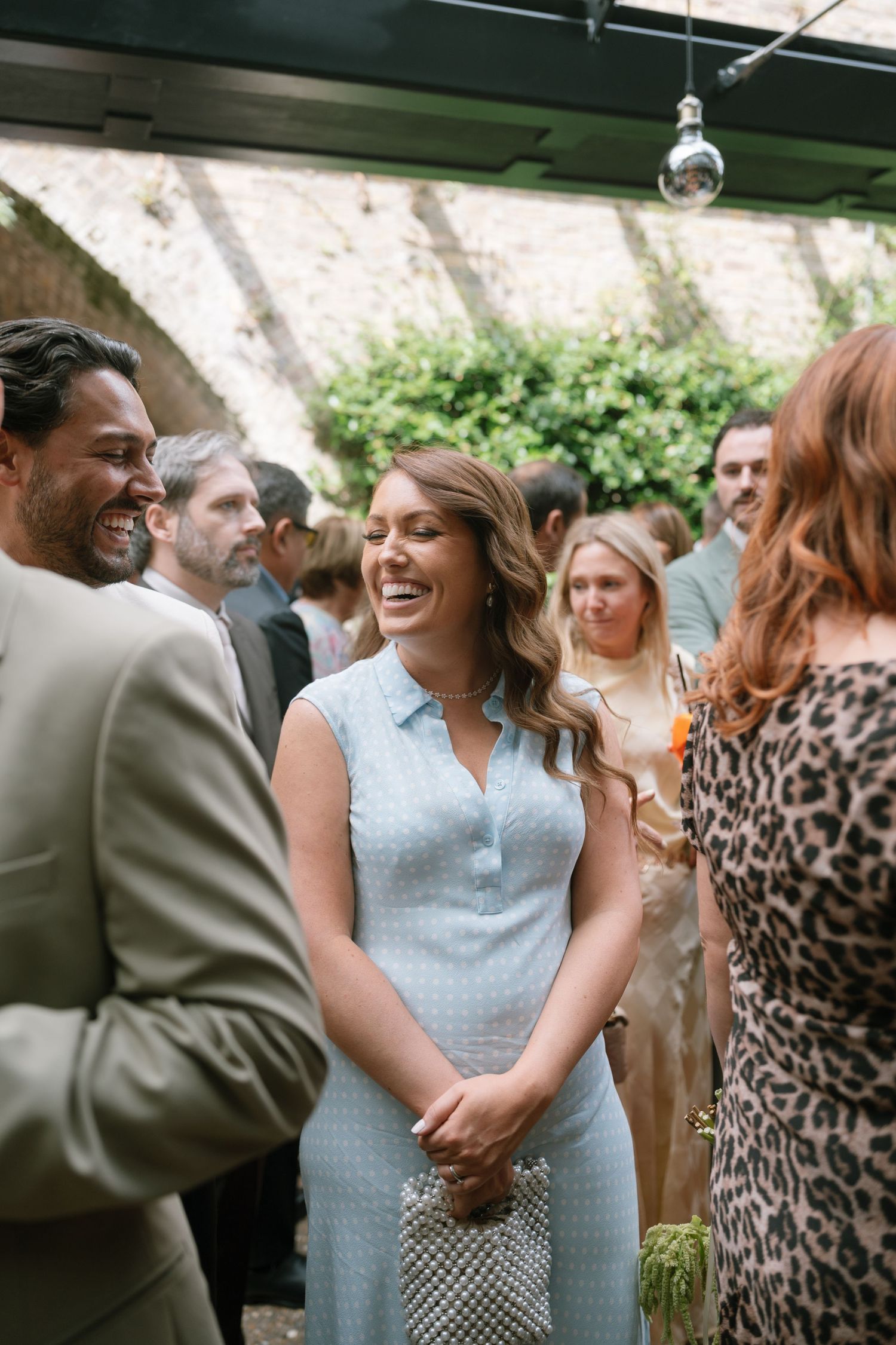 Wedding guests enjoying a lively outdoor reception with joyful dancing and celebration.