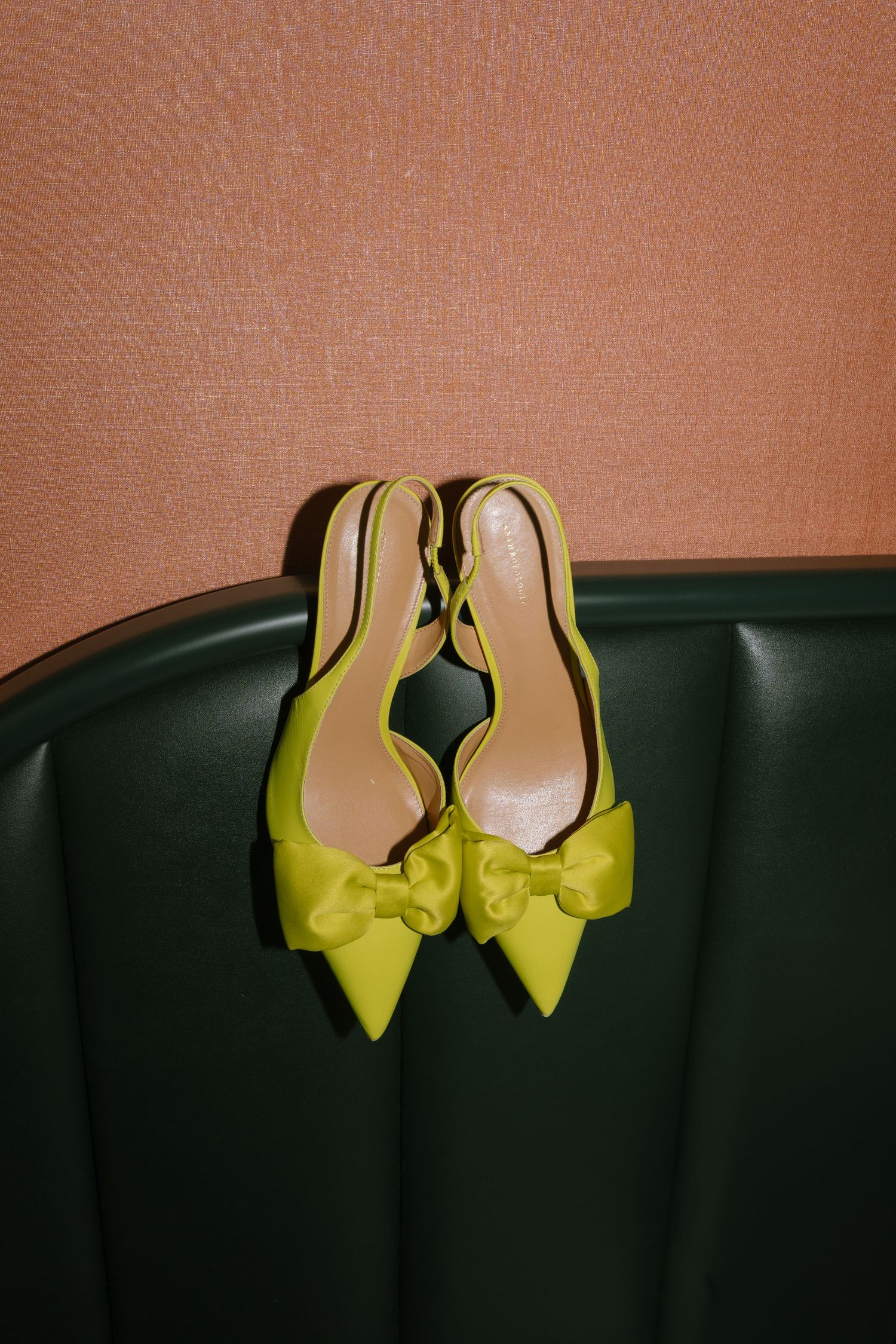 Yellow high heel shoes arranged in a row against a dark background.