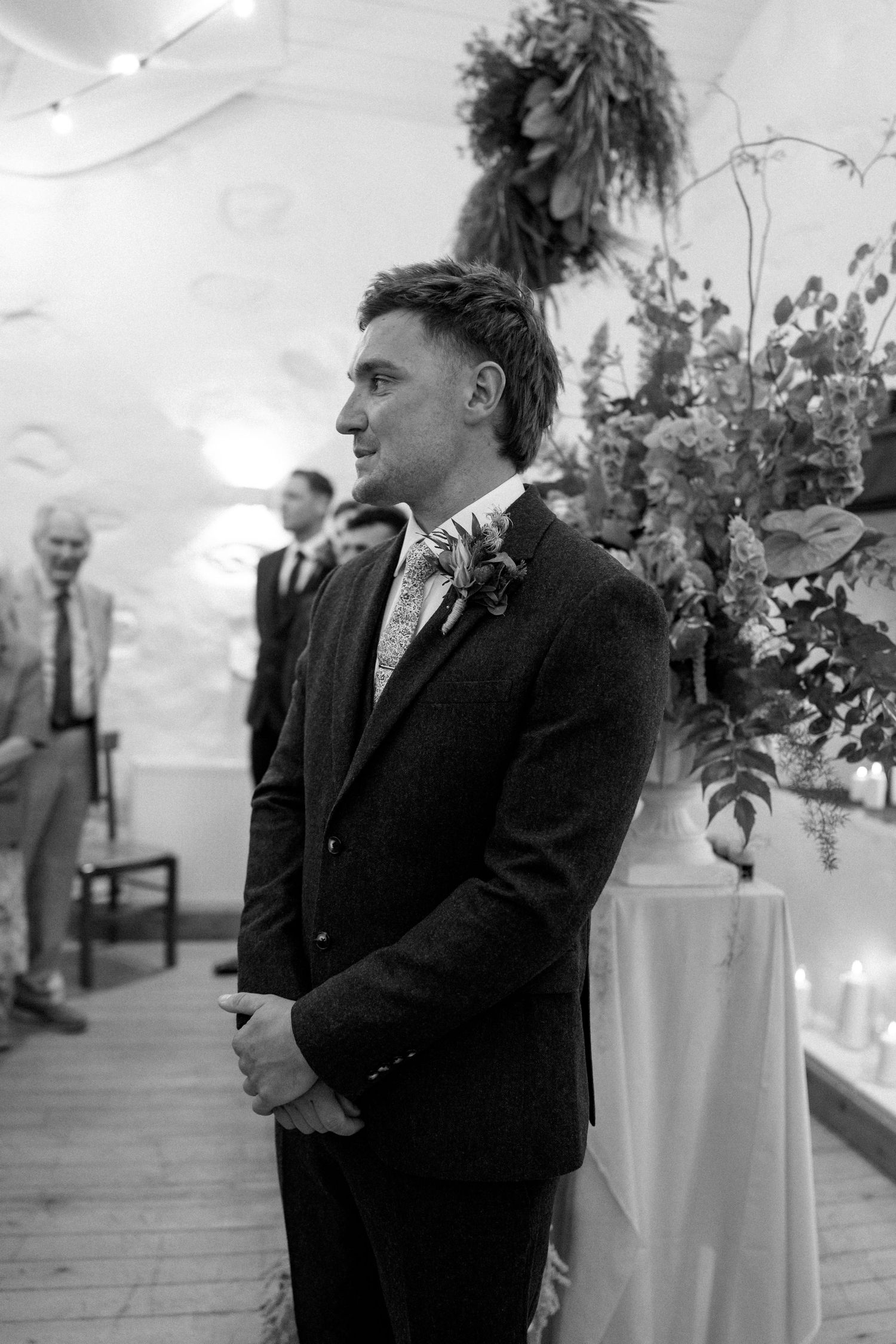 Black and white photos of wedding ceremony preparations in indoor venue.