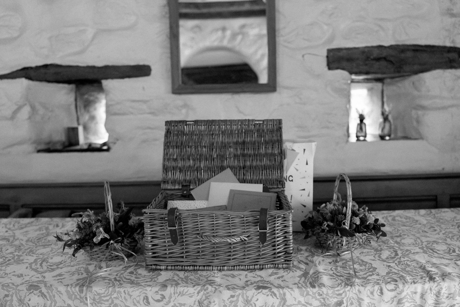 Interior view of rustic stone walls with decorative shelving and ornaments.