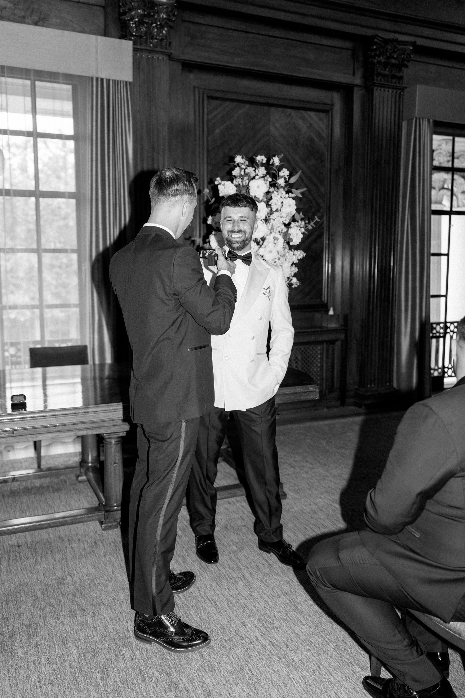 Black and white sequence of formal-dressed people dancing at a wedding reception.