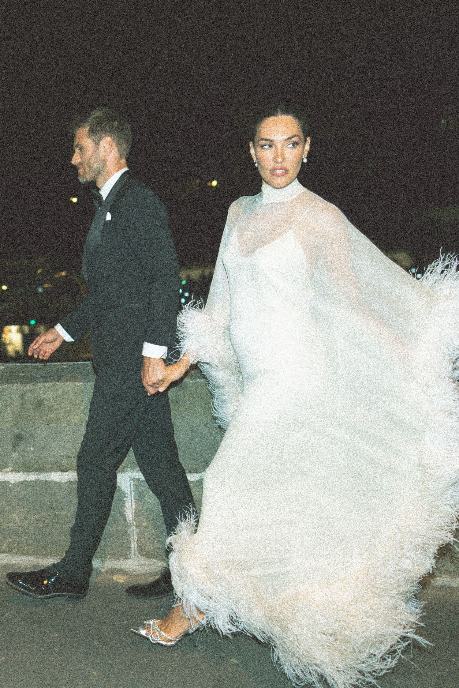 A couple walks together at night with the bride's white wedding dress flowing dramatically behind them in multiple photos.