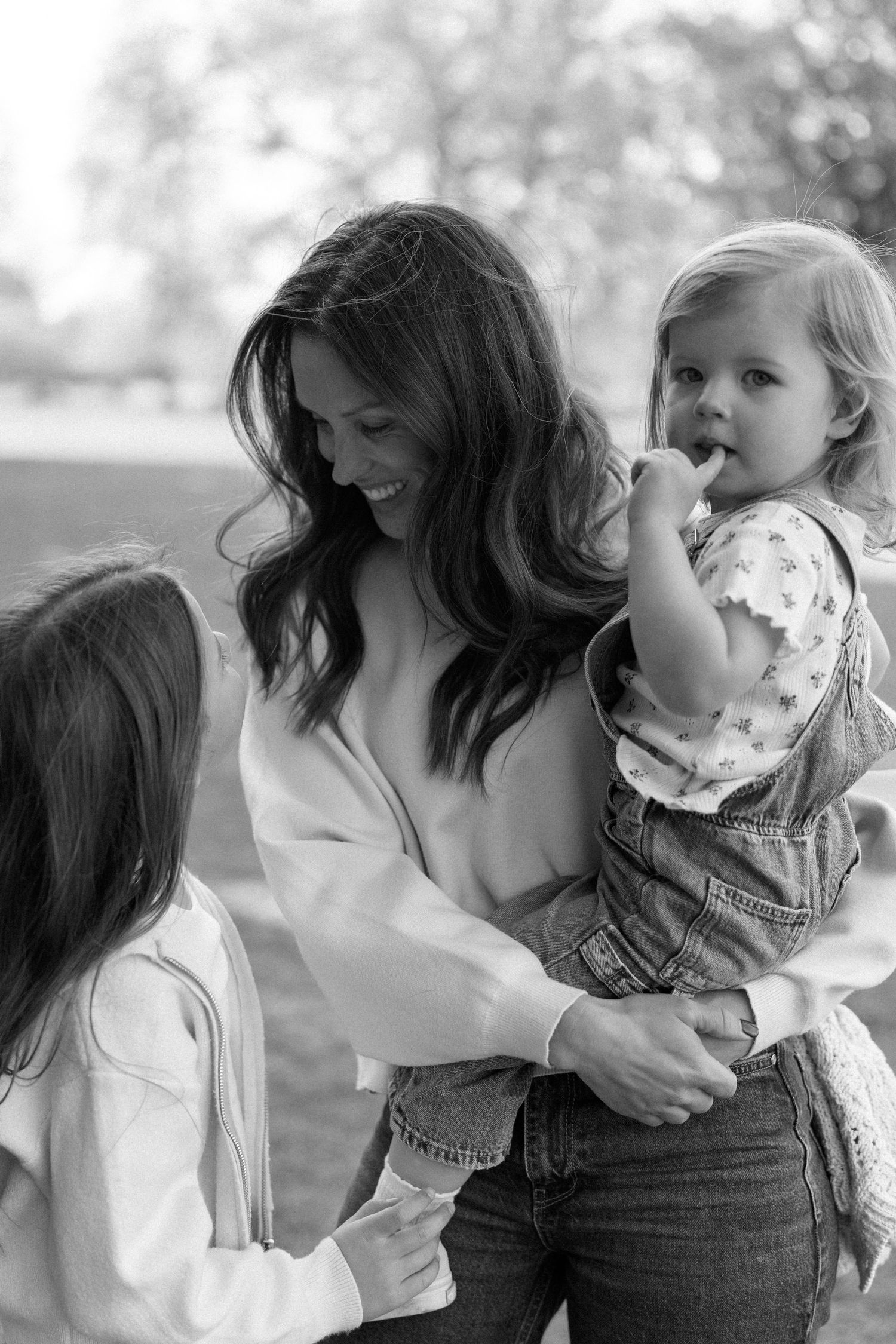 A tender black and white photo sequence captured in a park setting.