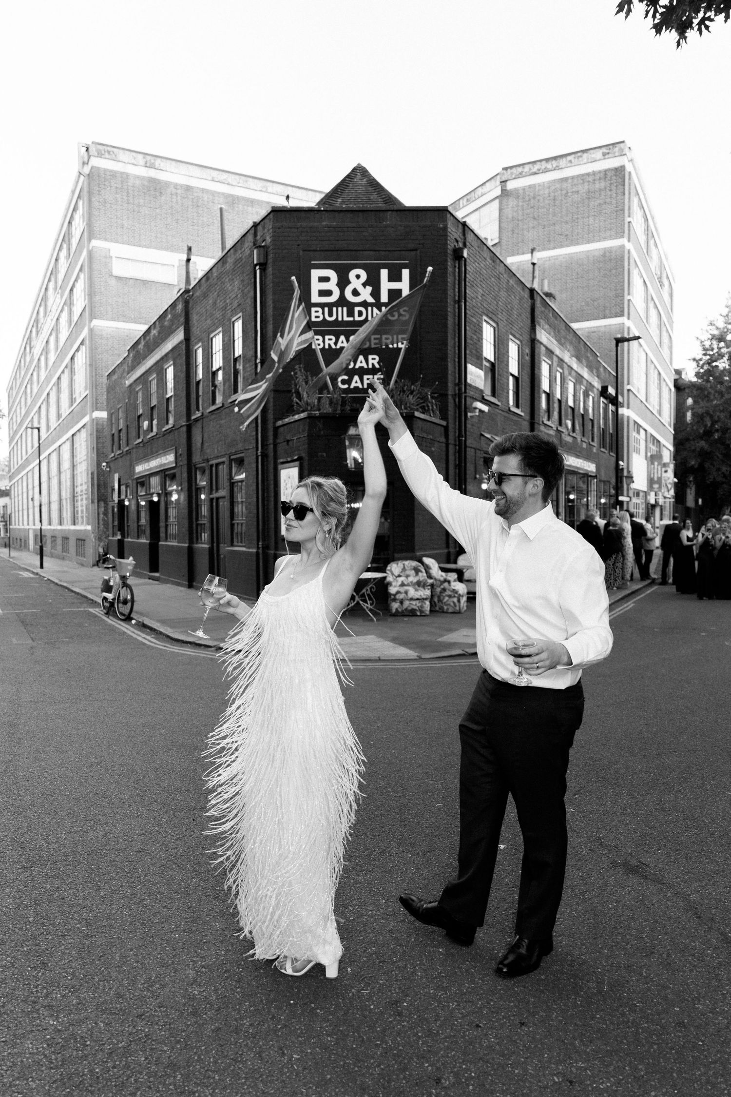 Couple dancing in front of B&H building in black and white photography.