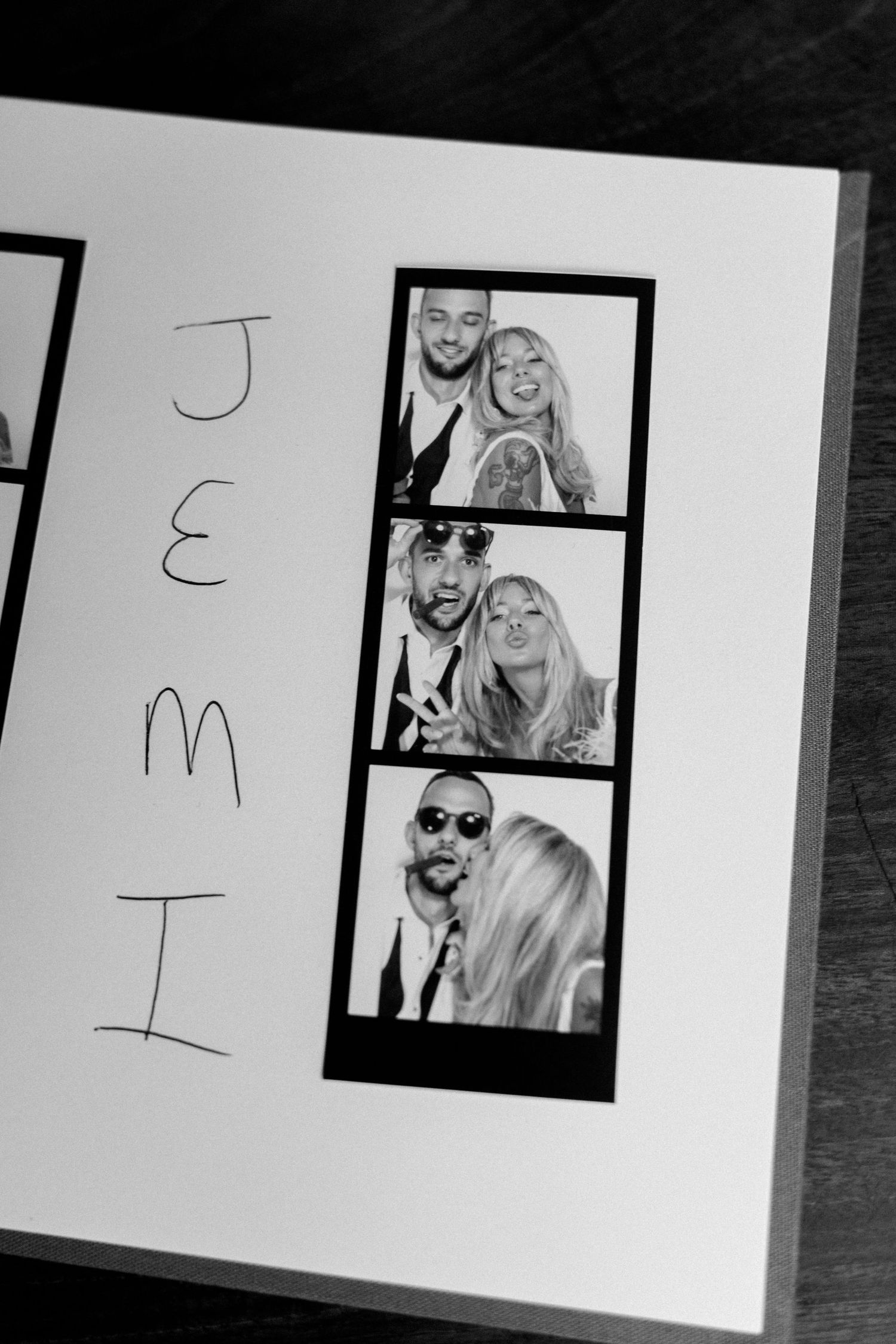 Black and white photo strip display showing multiple poses from a wedding photo booth.