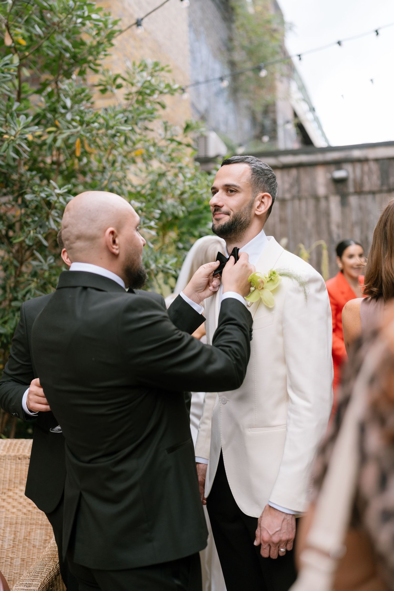 Wedding photographer capturing moments during an outdoor celebration.