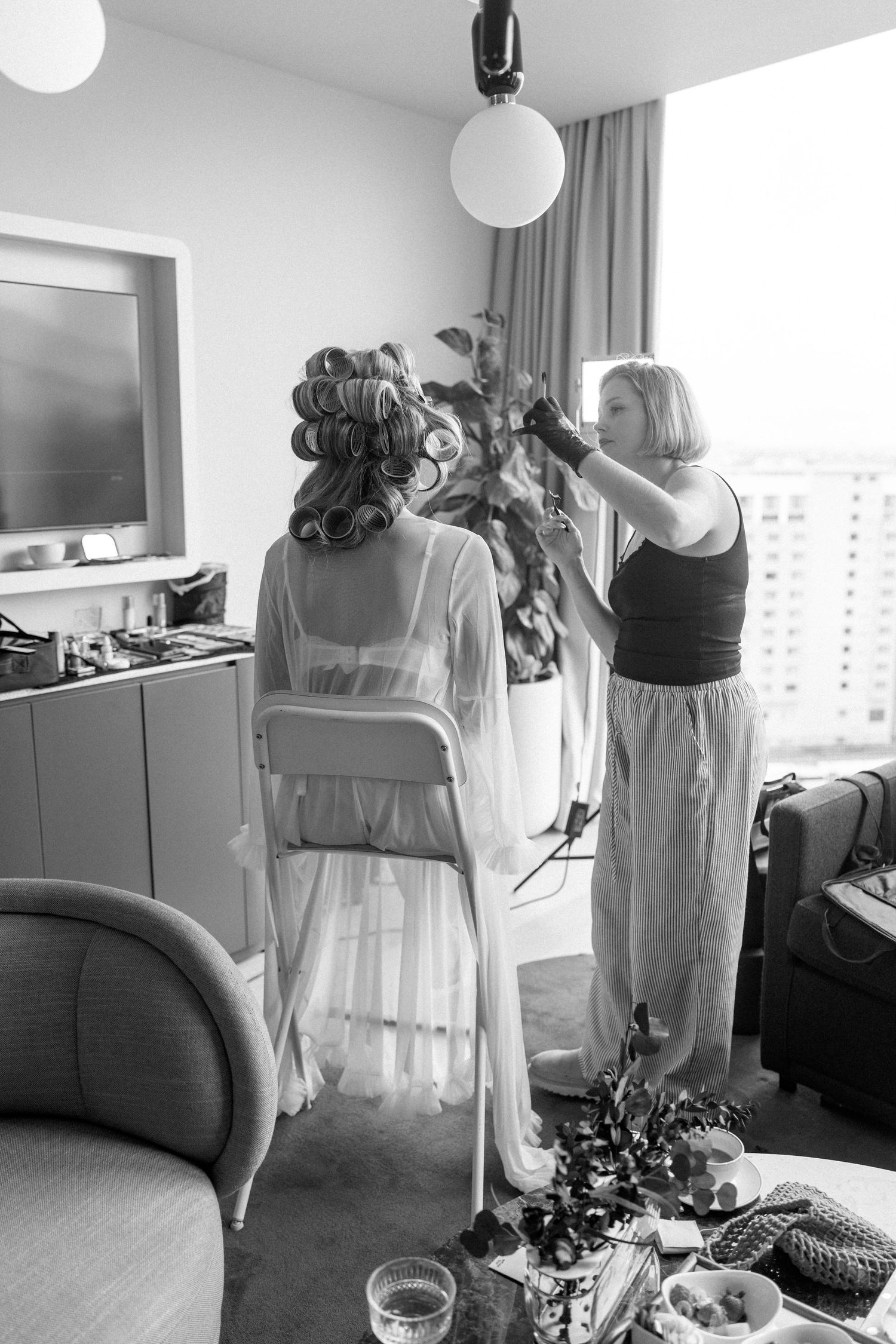 Wedding dresses hanging on display in a bright modern room with white decor.