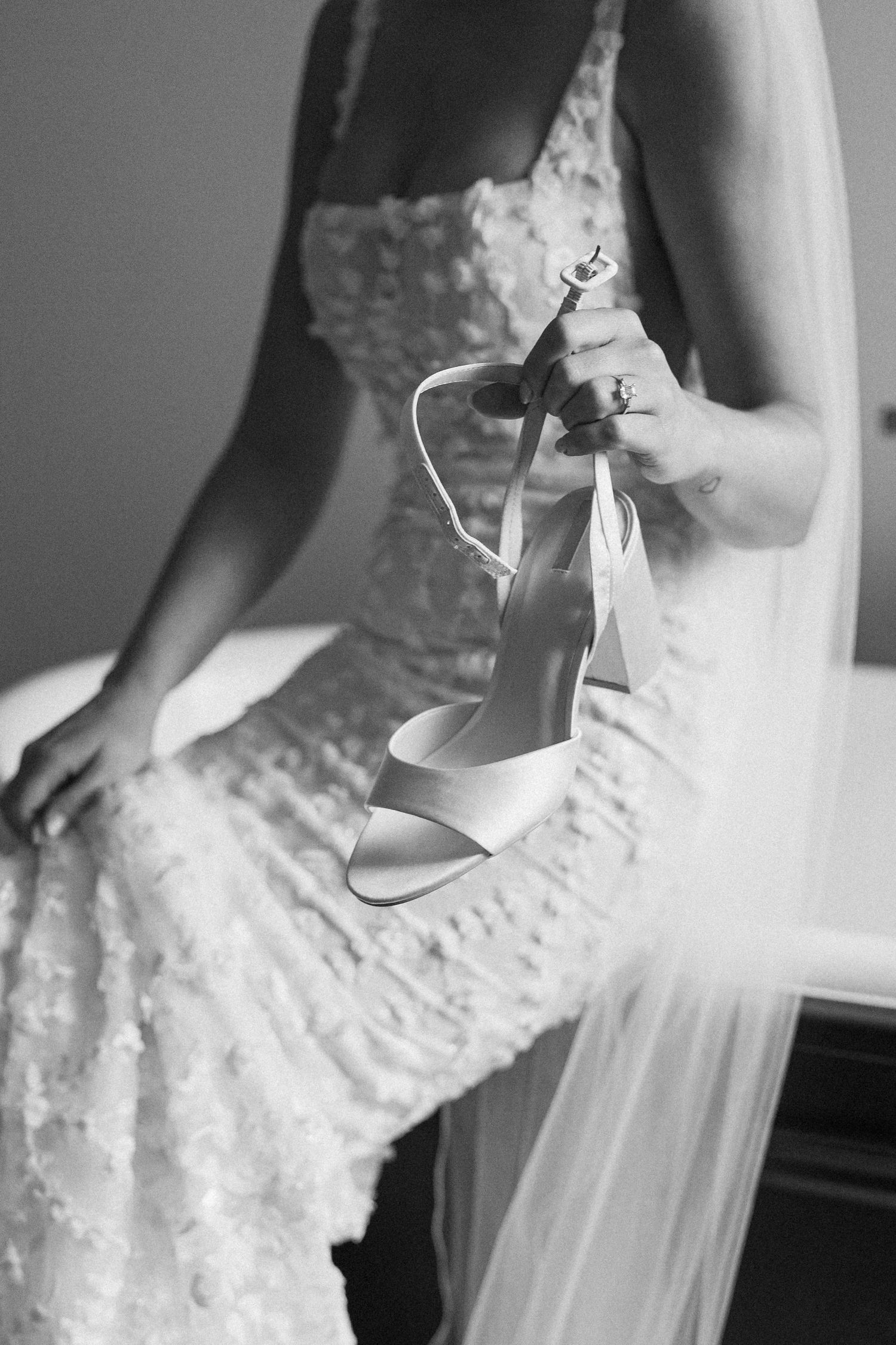 Close-up details of a fitted lace wedding dress bodice in black and white.