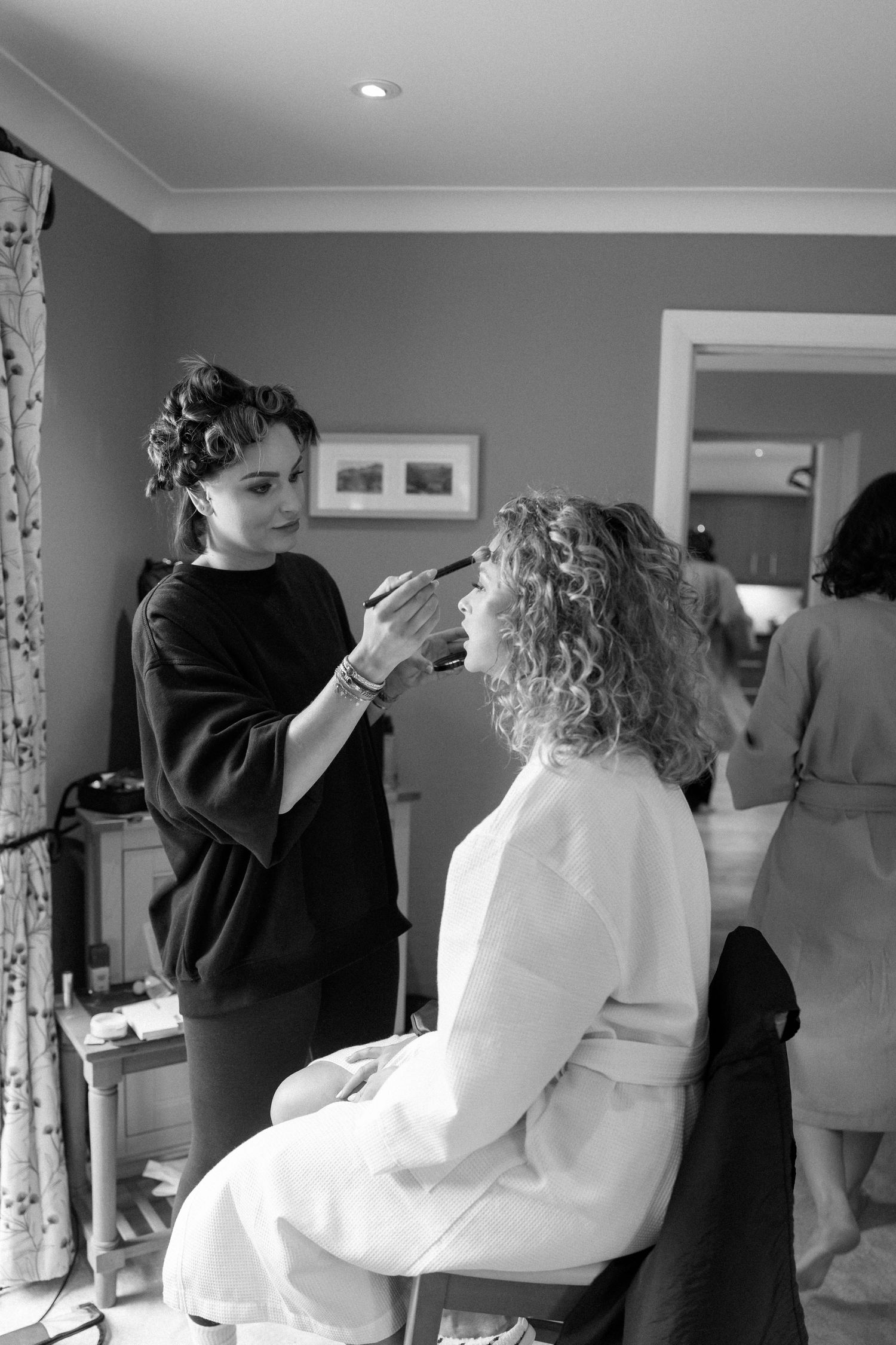 People getting ready in white robes in a bright modern room.