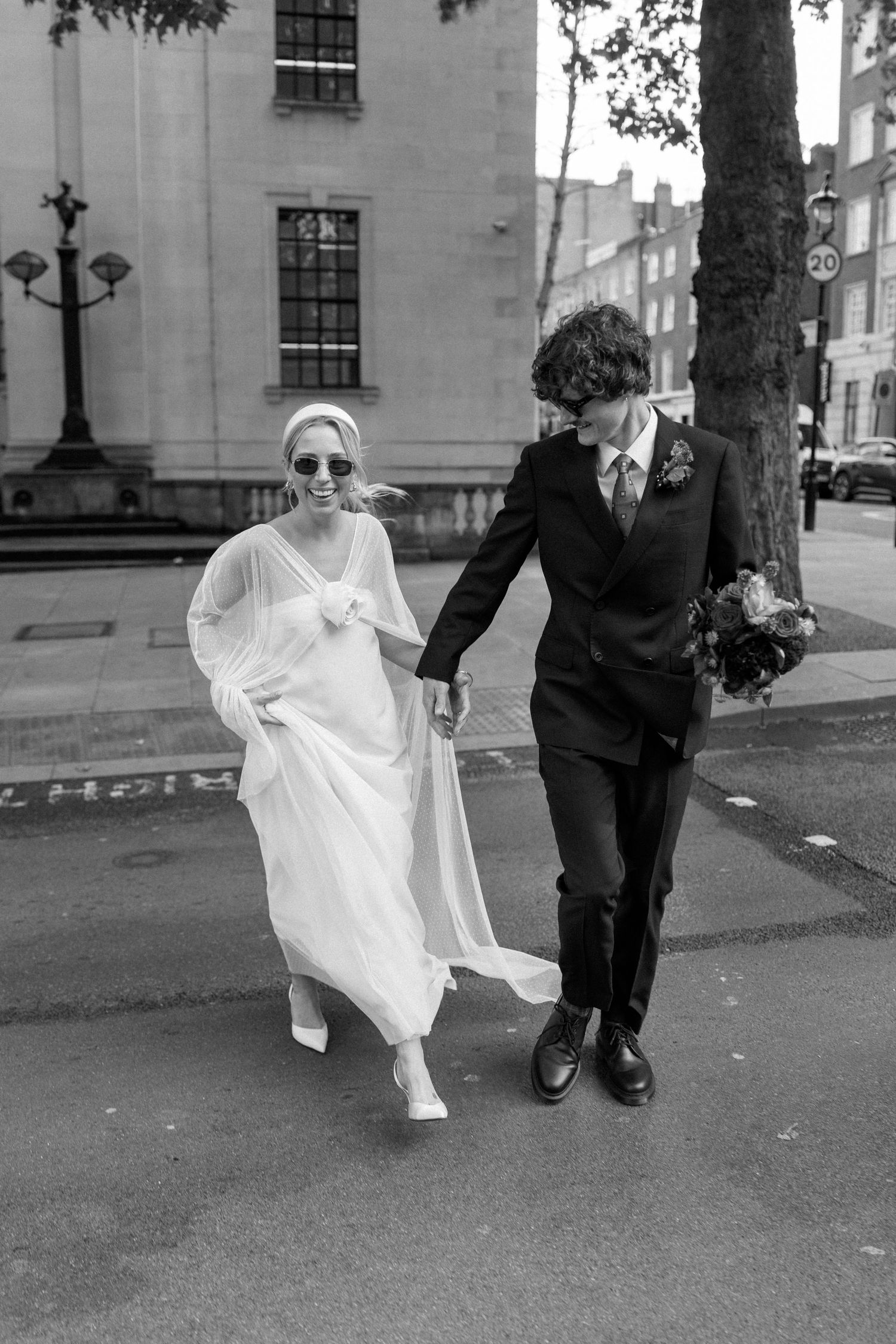 Dynamic black and white wedding photos showing couple running and playing outdoors.