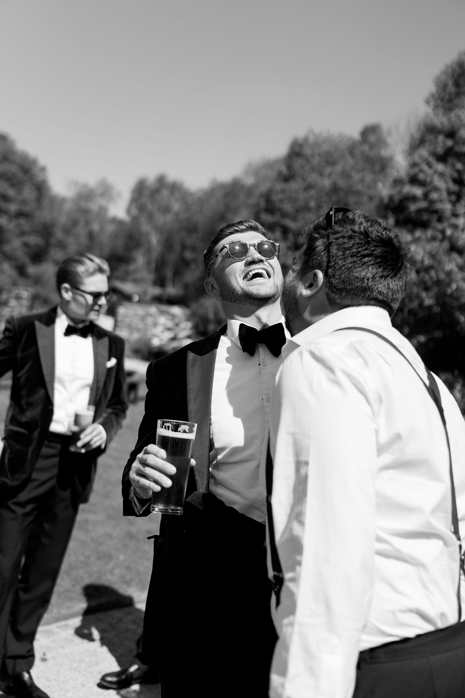 Candid moments of wedding party members laughing and interacting outdoors.