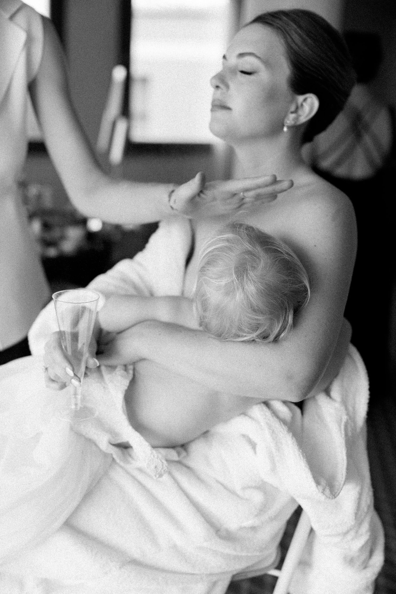 An intimate black and white portrait showing tender moments of preparation.