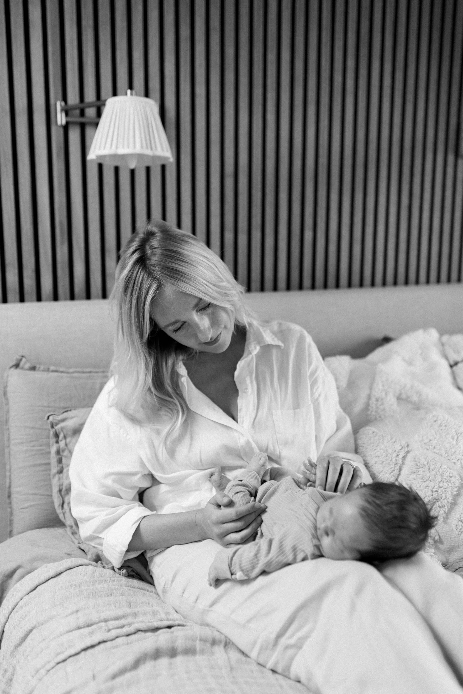 A tender black and white series of intimate moments showing parent and baby bonding in white clothing.