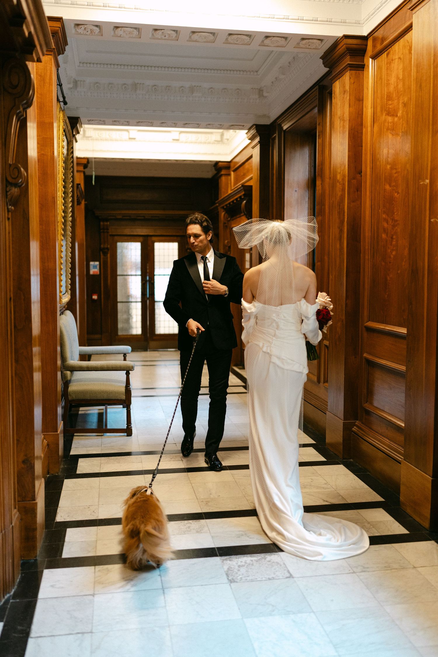 A series of wedding photos in a grand hallway with wood paneling and marble floors.