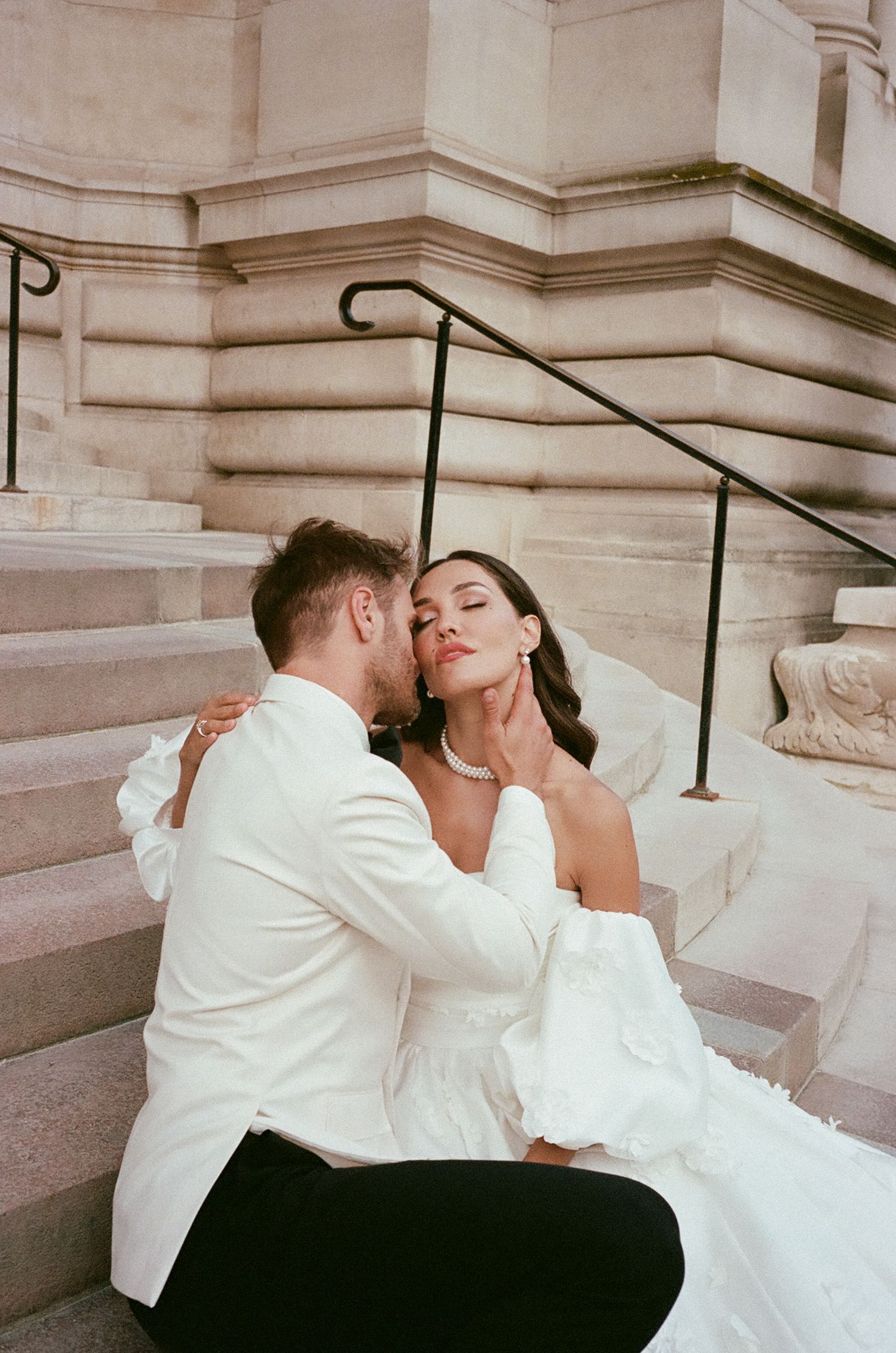 A romantic sequence of wedding photos showing a couple embracing on grand stone steps in formal white attire.