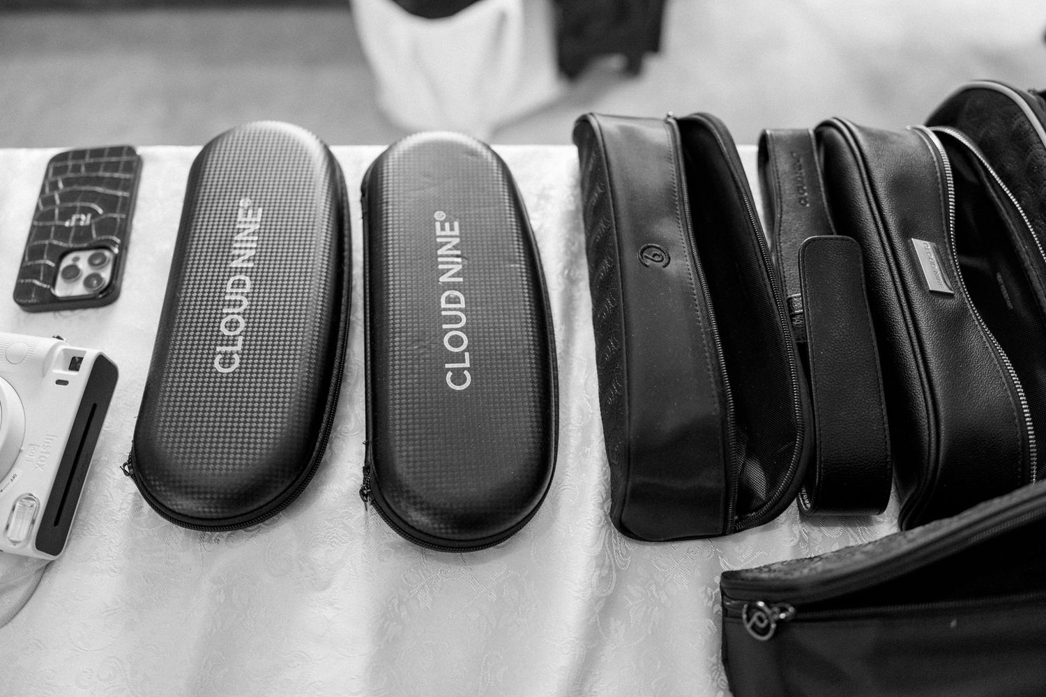 Row of black computer mice arranged in a line on a white surface.