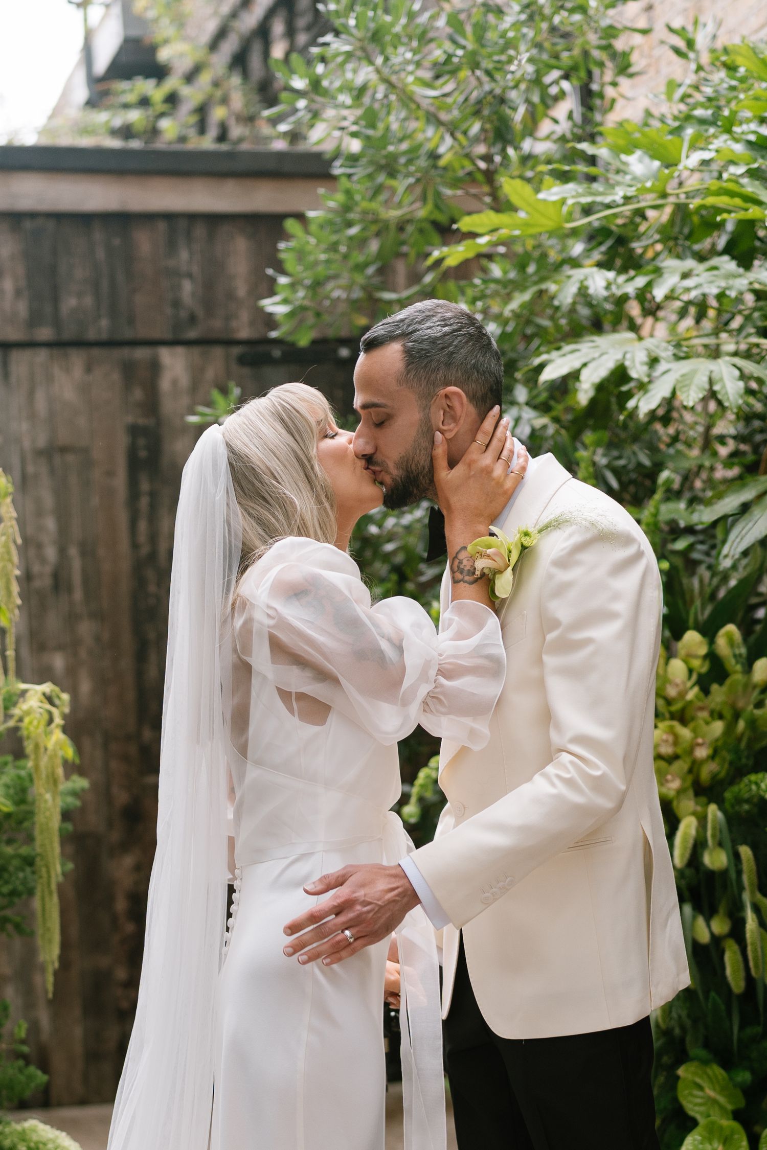 Romantic wedding photo series in a garden setting with white attire.