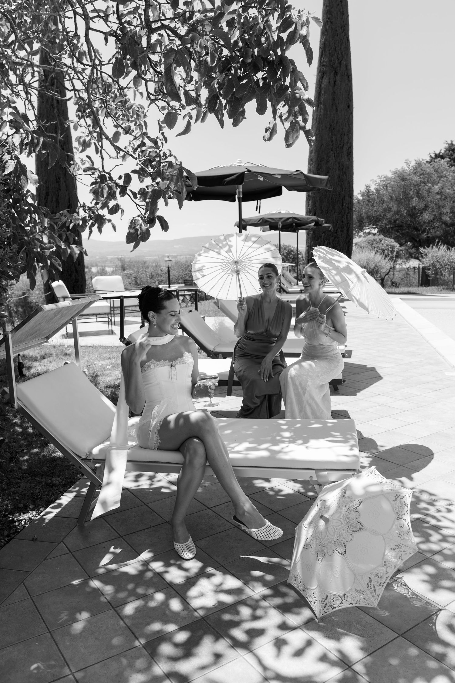 A sequence of playful umbrella dance moves captured in bright sunlight on a patio.