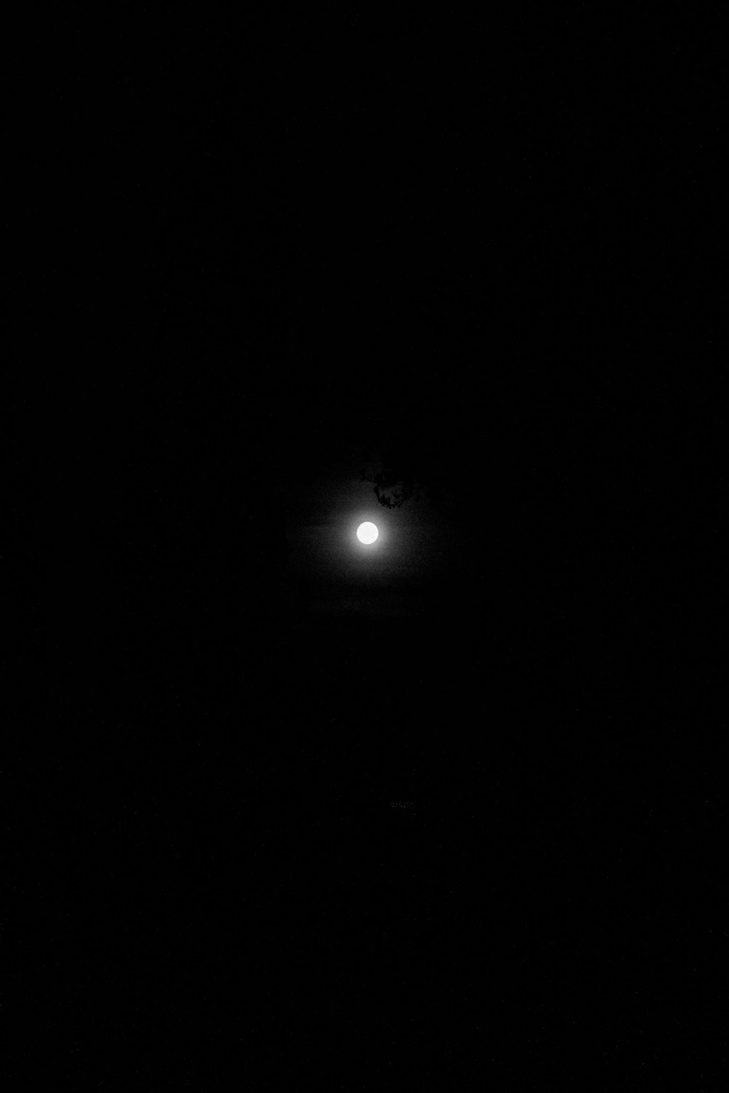 Two bright lights glowing in complete darkness.