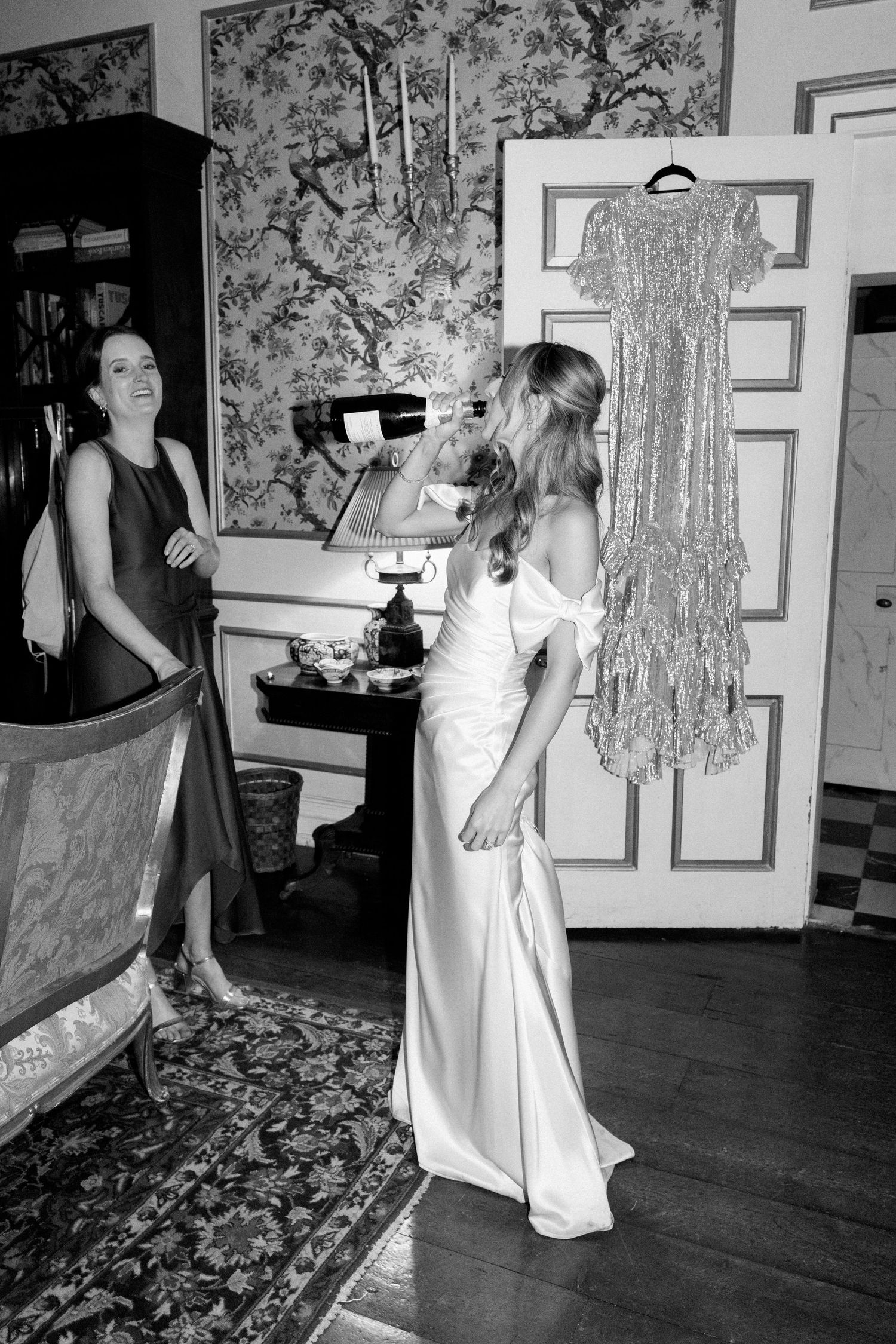 Wedding celebration scene with silver dress display and formal evening attire.