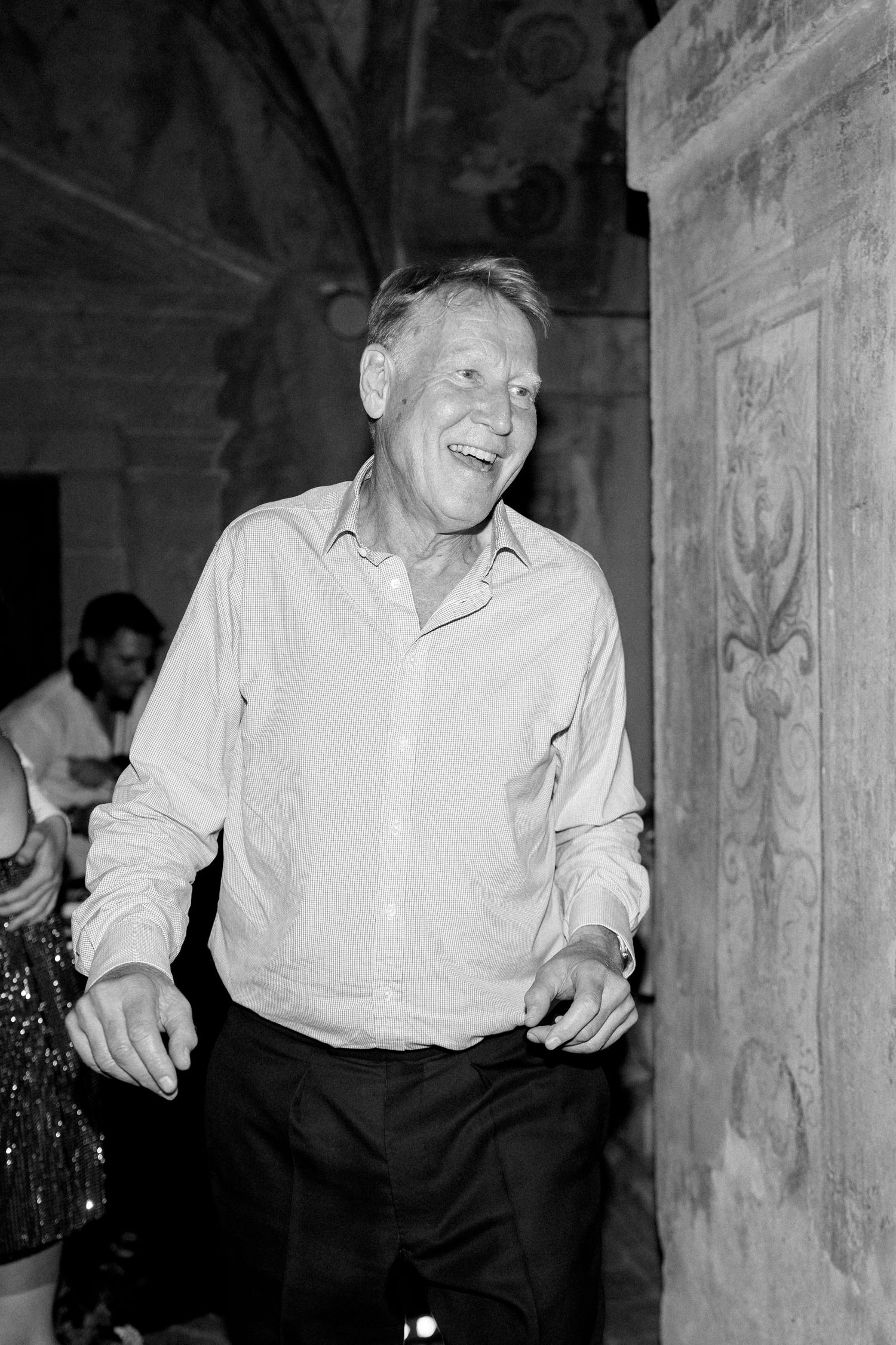 Series showing joyful dancing moments in a historic stone building.