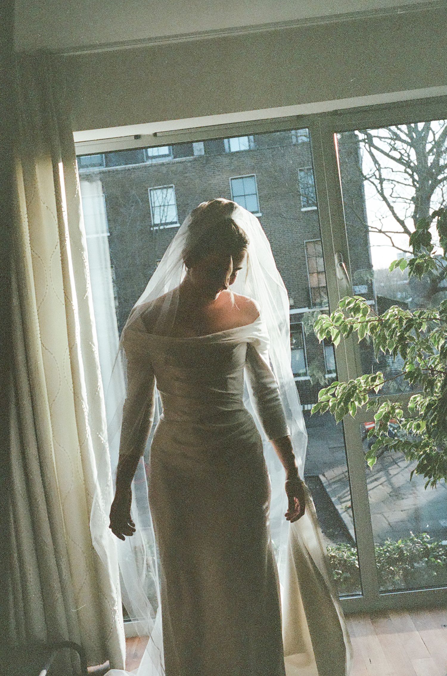 A series of candid movement shots near large windows in a bright interior space.