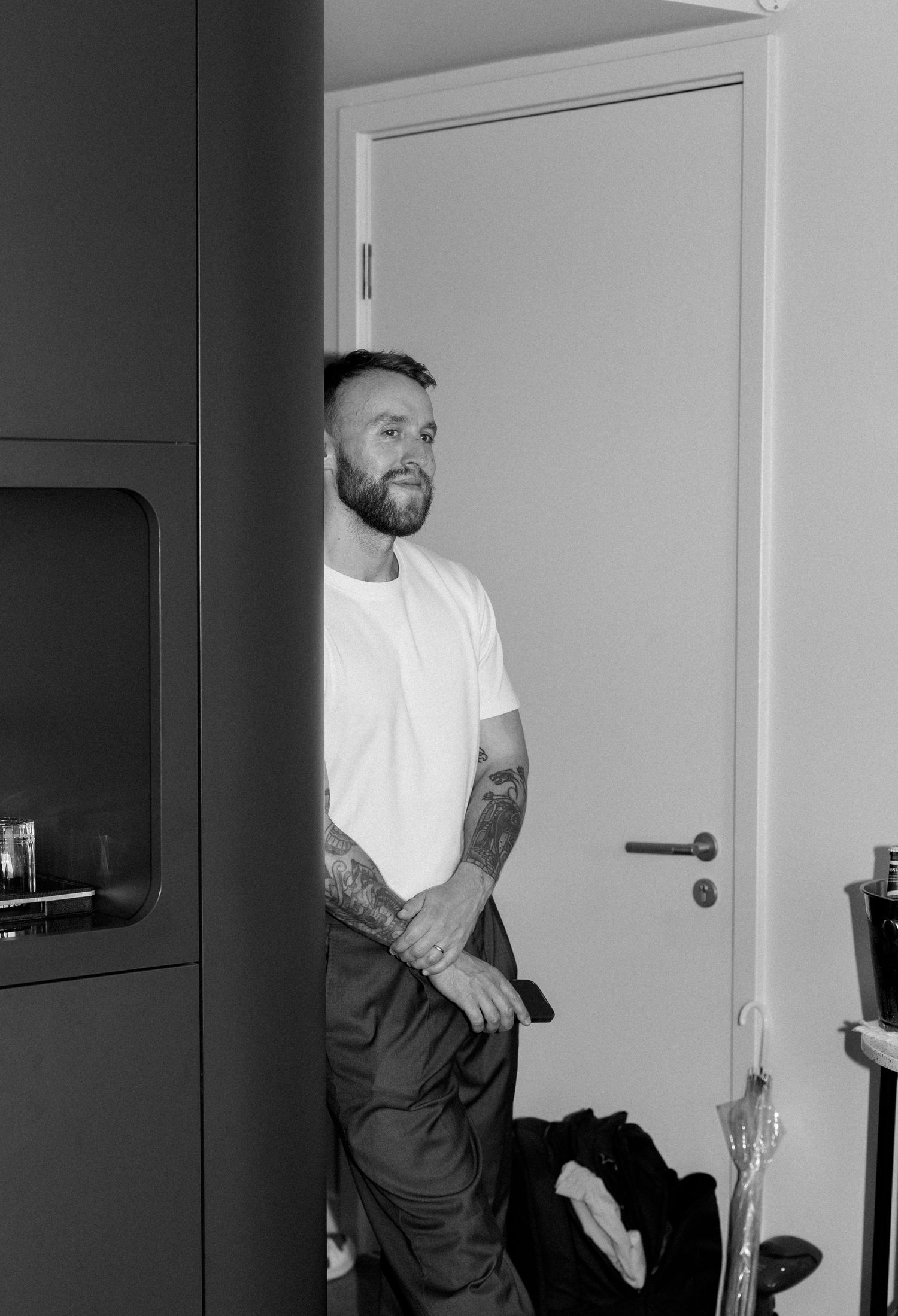 Black and white photos of someone in a white t-shirt getting ready.