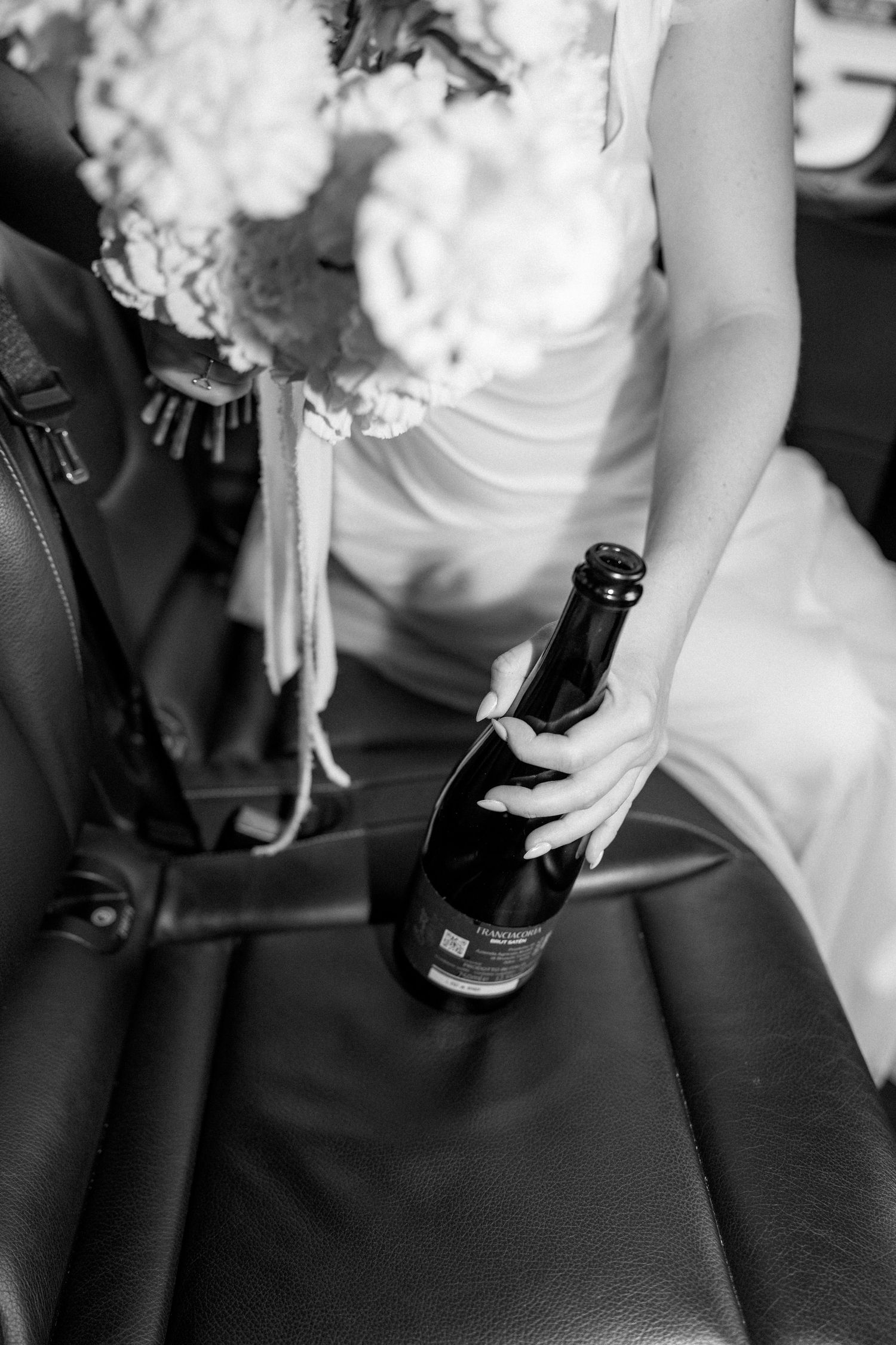 Detail shots of hands holding a white bouquet against black car upholstery.