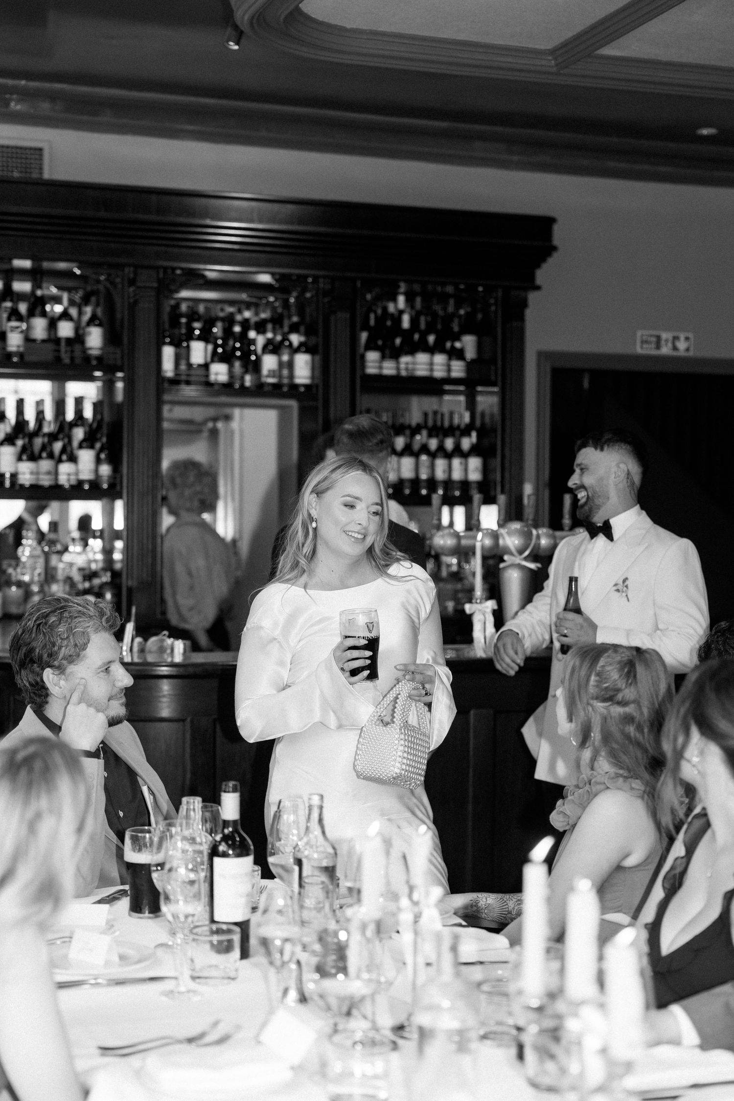 Reception celebration at an elegant bar with guests mingling and enjoying drinks.