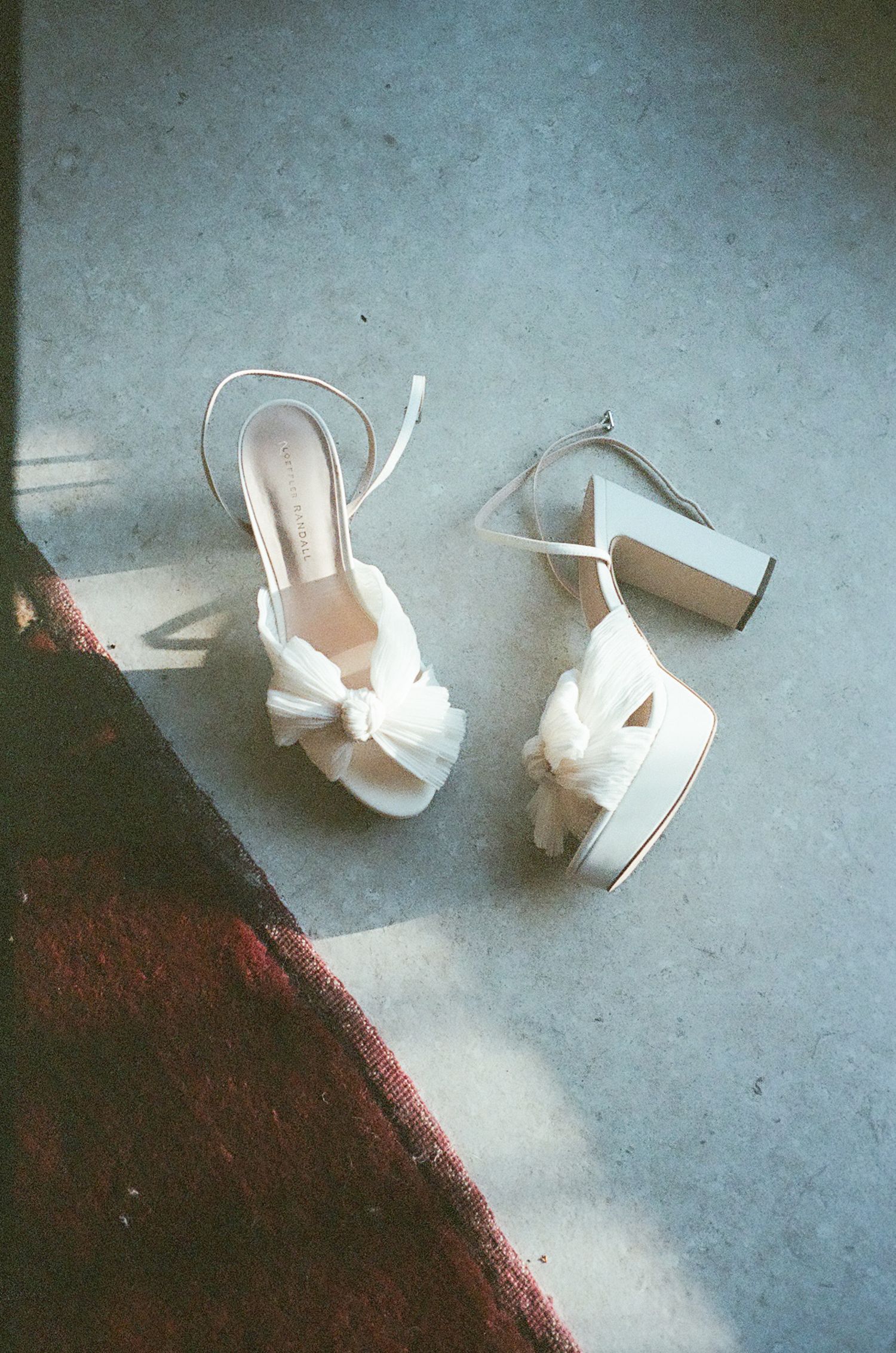 Broken white ceramic pieces scattered across a dark surface in sequence.